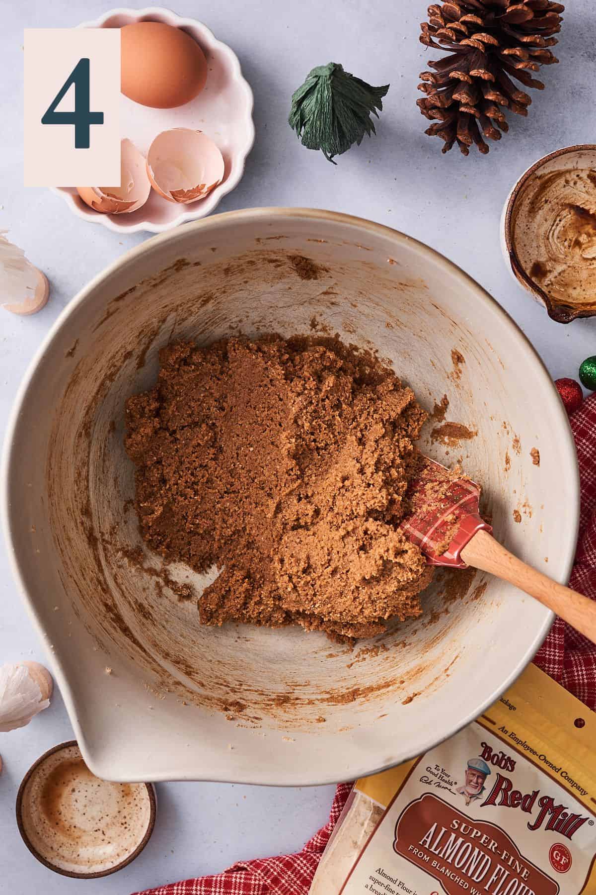 cookie dough mixed together in a large mixing bowl, with bob's red mill almond flour in the lower right hand corner. 