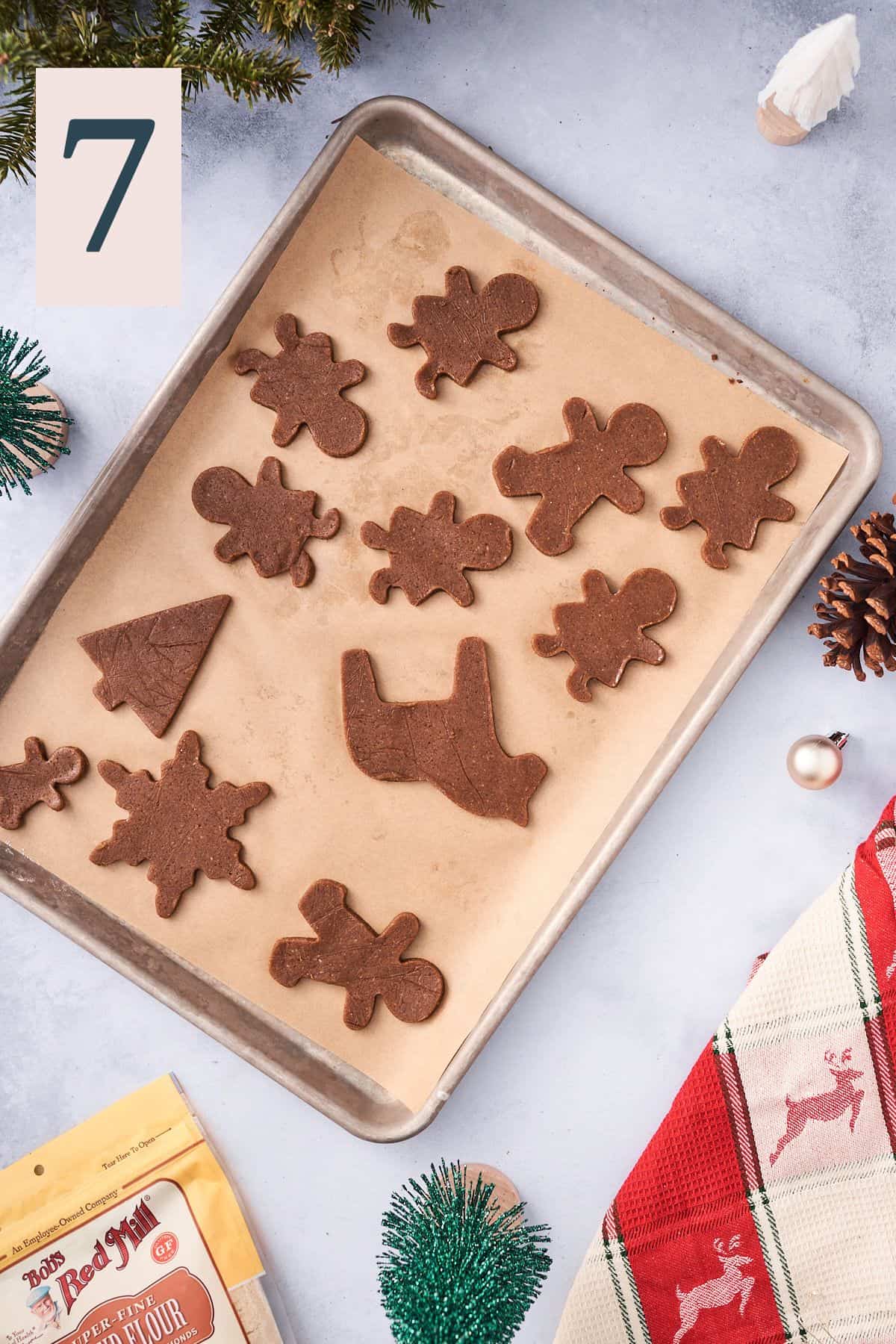 gingerbread cookie dough on a parchment lined baking sheet. 