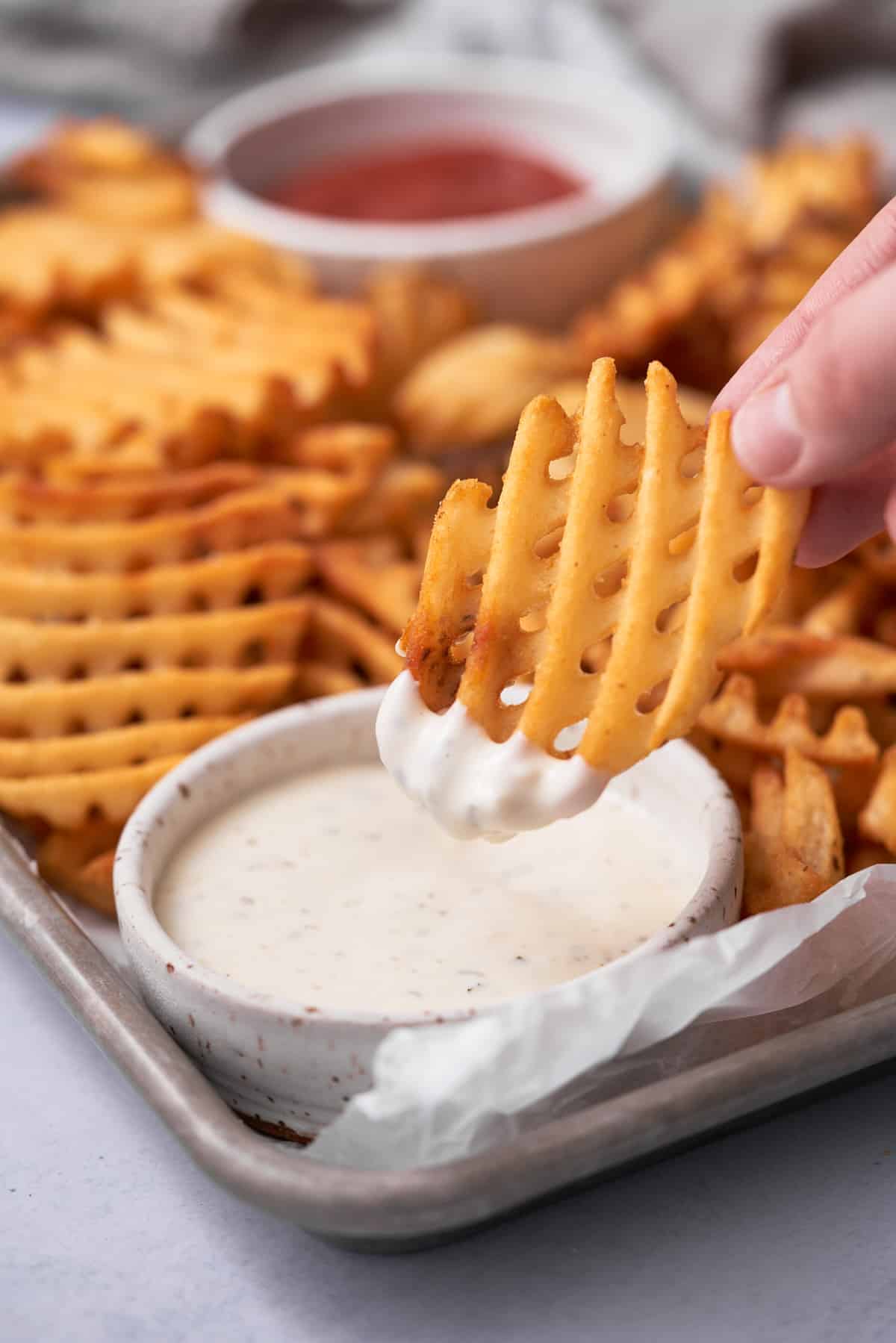 handheld waffle fry dipped in ranch.