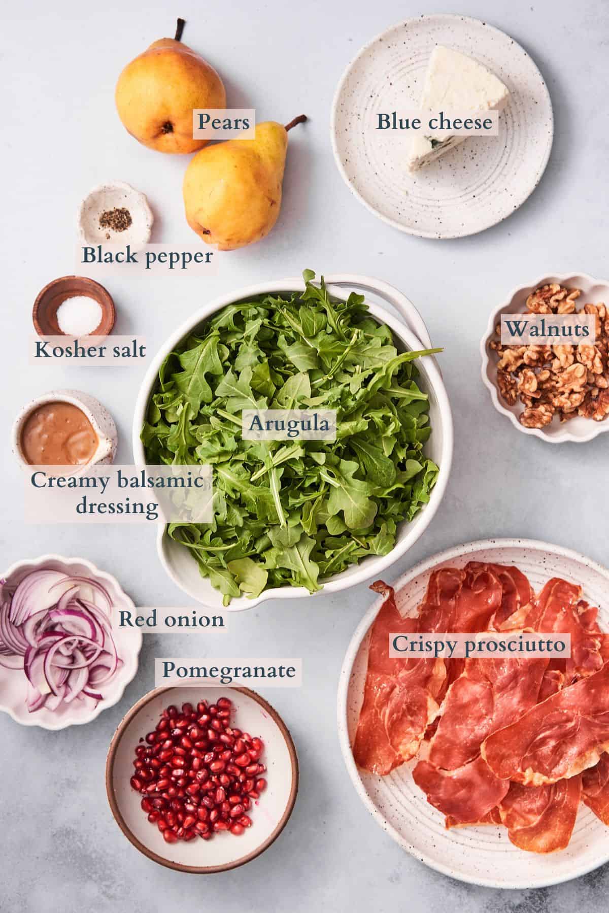 arugula pear salad ingredients graphic, with text overlaying to denote each ingredient. 
