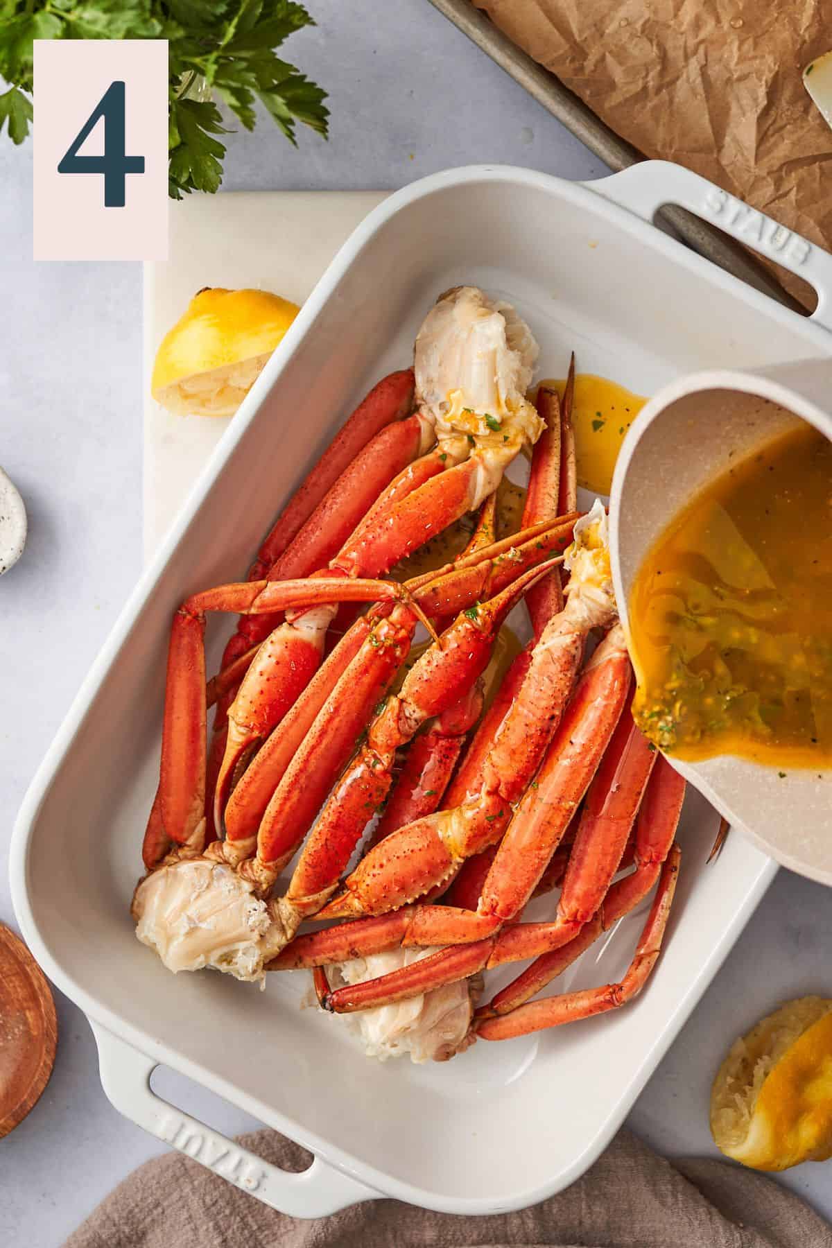Basting crab legs with butter sauce.