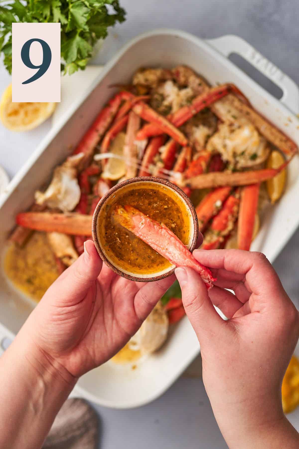Dipping crab meat into a spicy butter sauce.