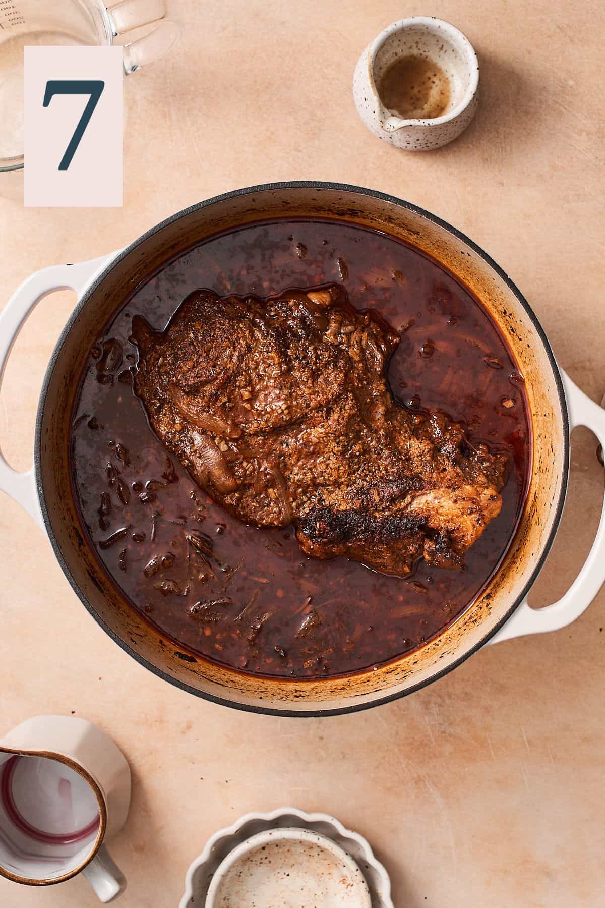 chuck roast cooked in an enameled dutch oven. 