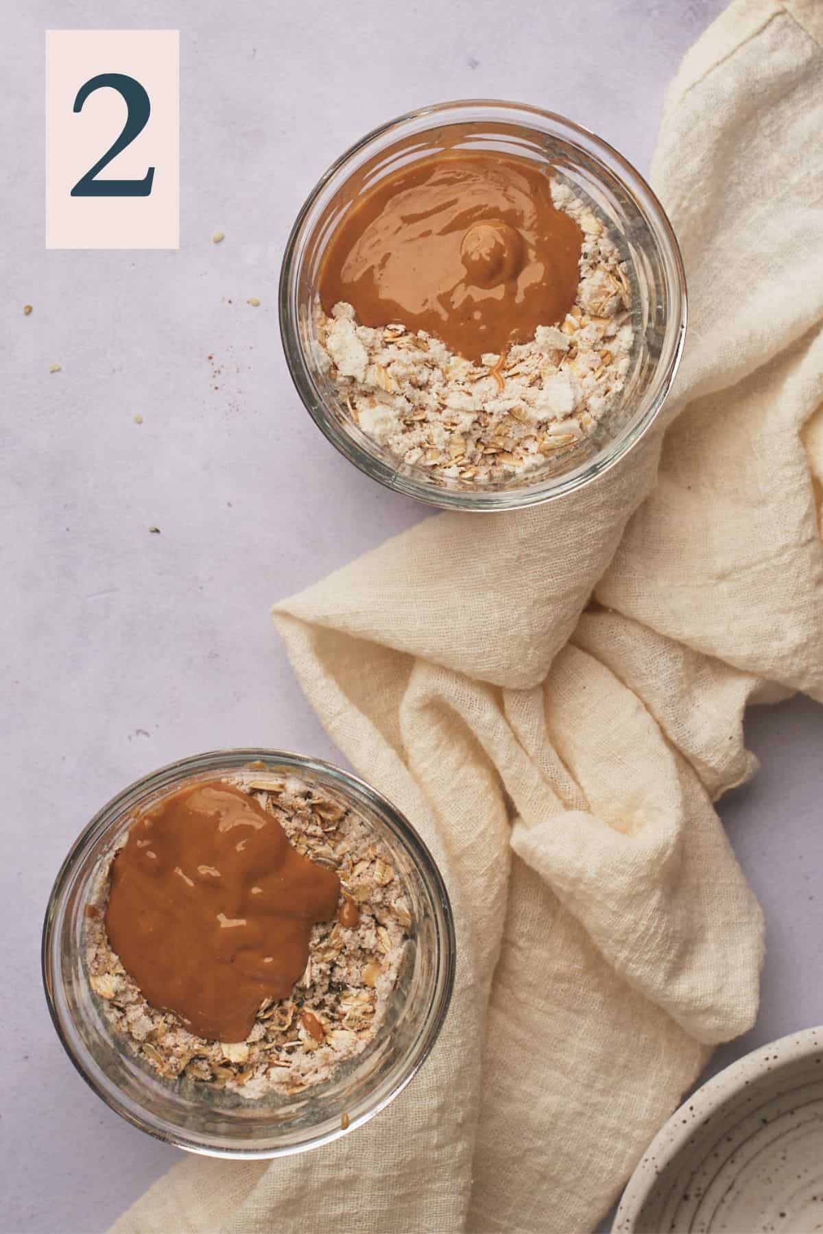 oats and other dry ingredients in jars topped with natural peanut butter. 
