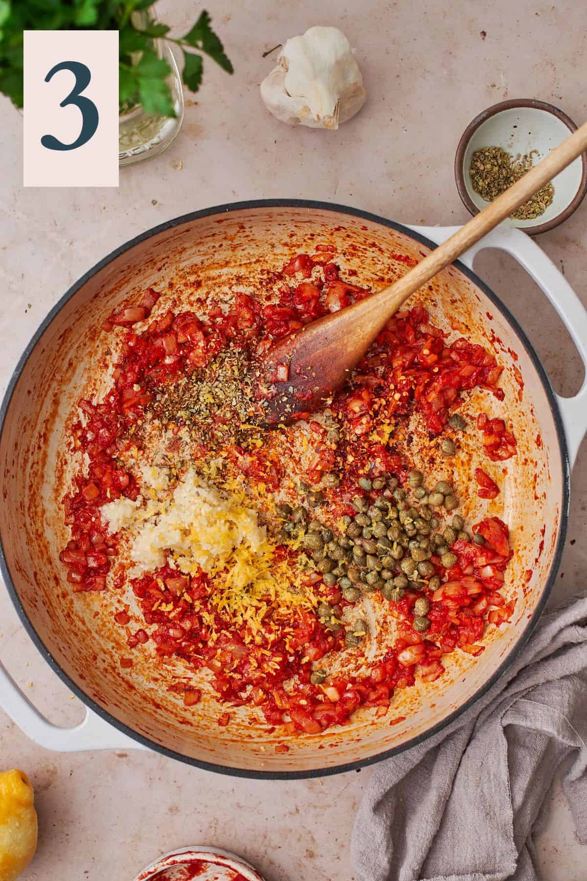 deepened color of tomato paste, along with garlic, dried herbs, lemon zest, red pepper flakes, and capers in a skillet.