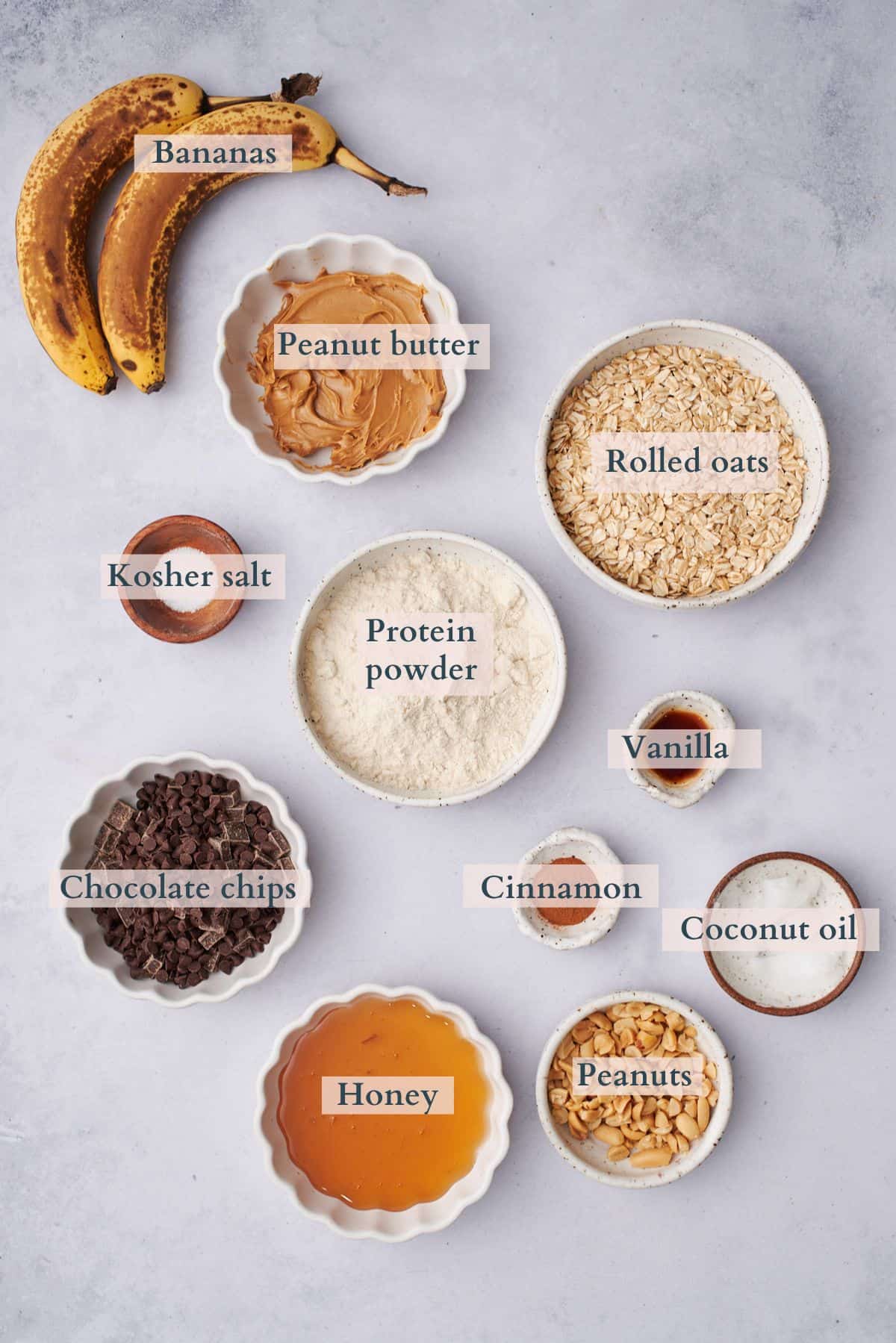 baked oatmeal cups ingredients laid out in various bowls.