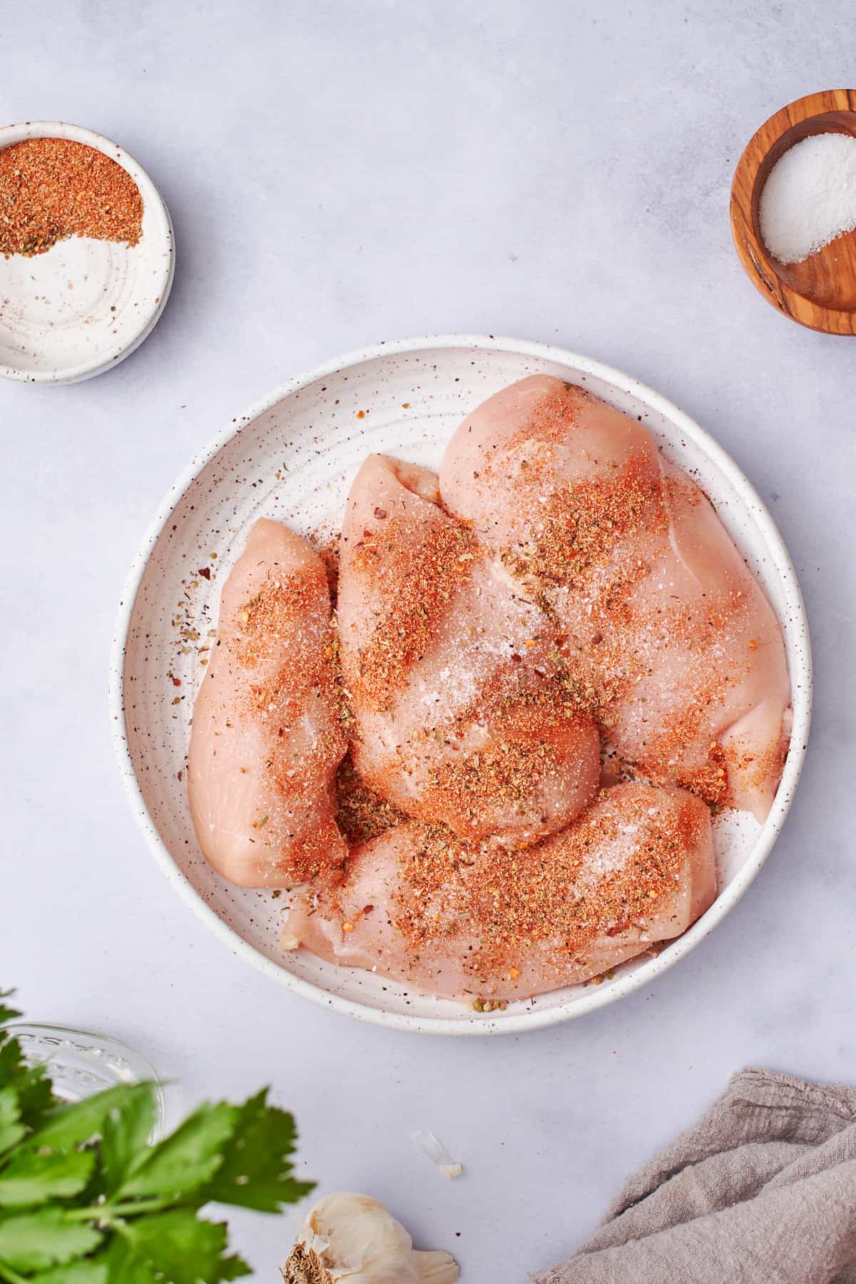 raw chicken seasoned with Cajun seasoning and salt.