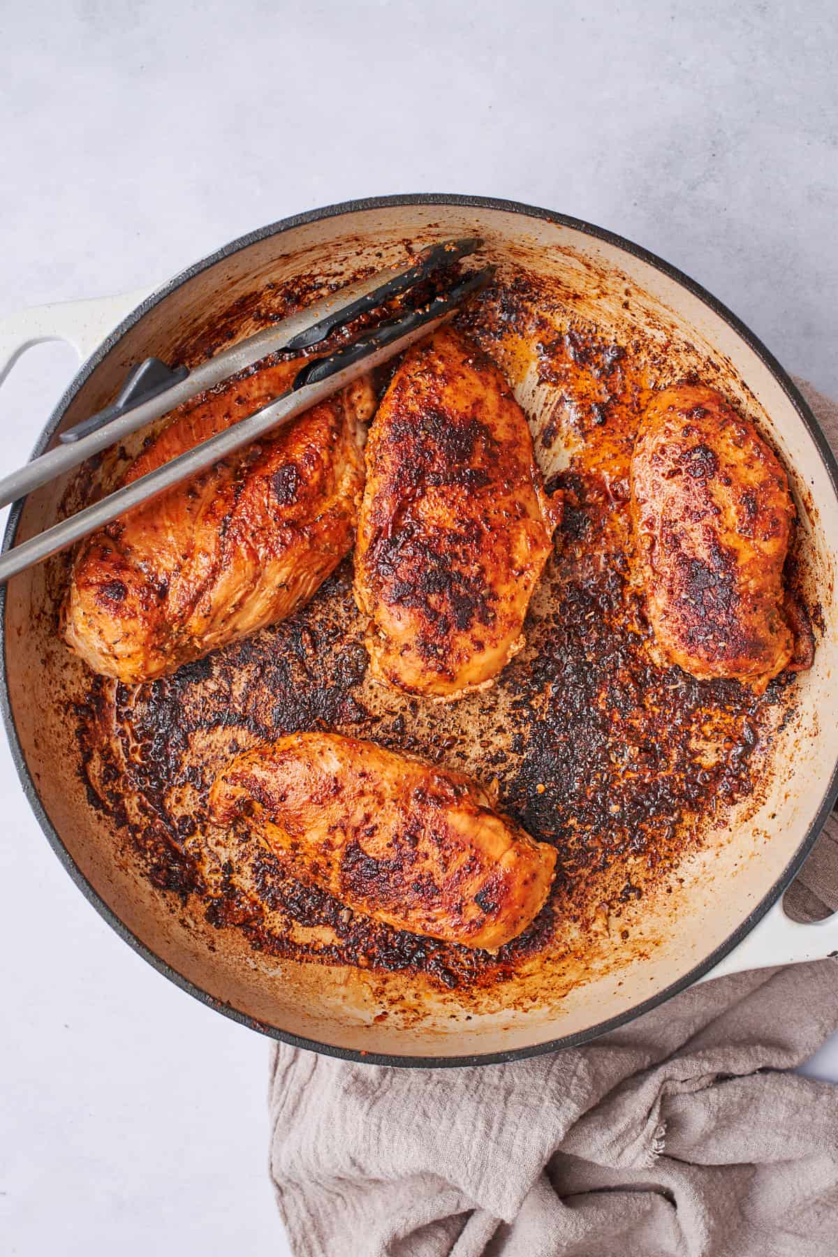 blackened Cajun chicken breasts in a skillet.