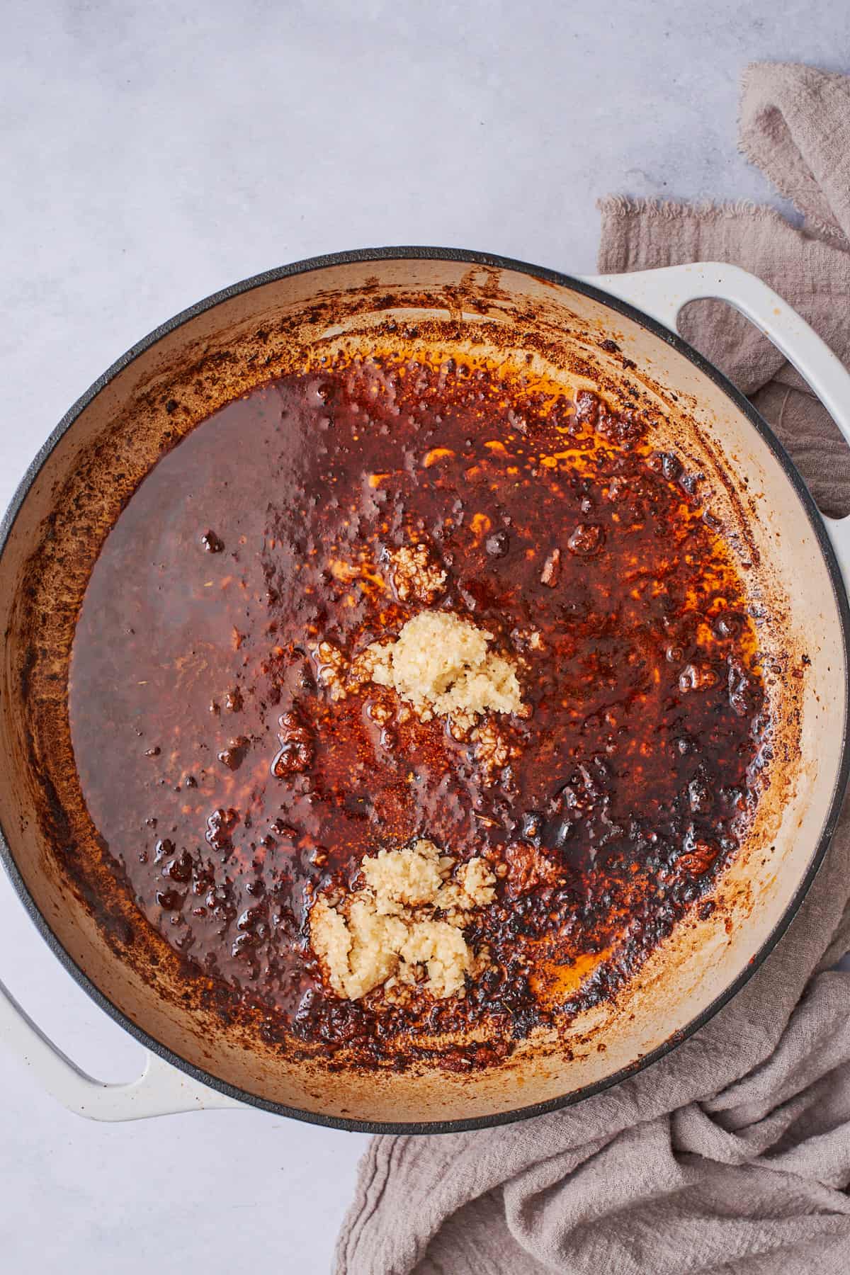 enameled cast iron skillet with a little bit of broth and blackening seasonings with butter and garlic.