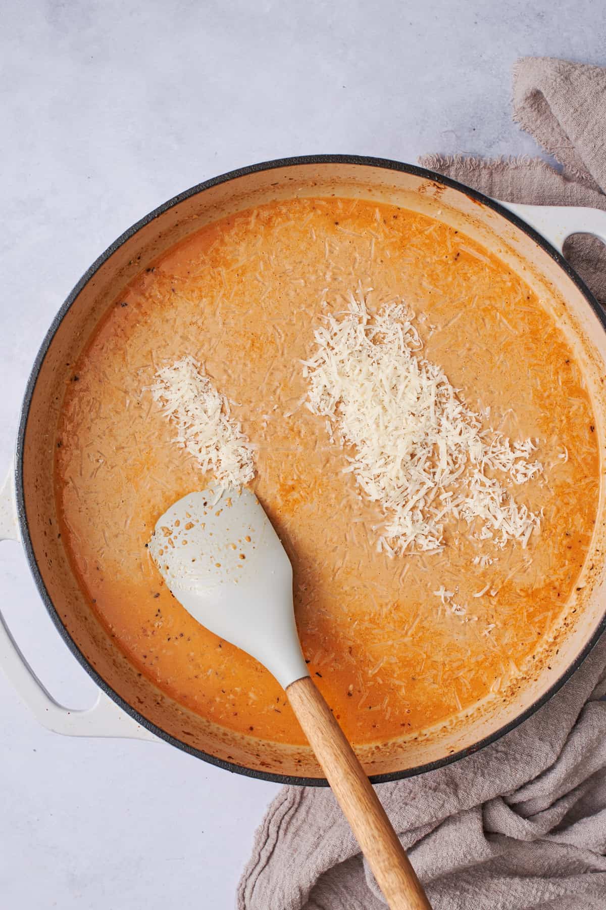 creamy broth with parmesan cheese added in a skillet.