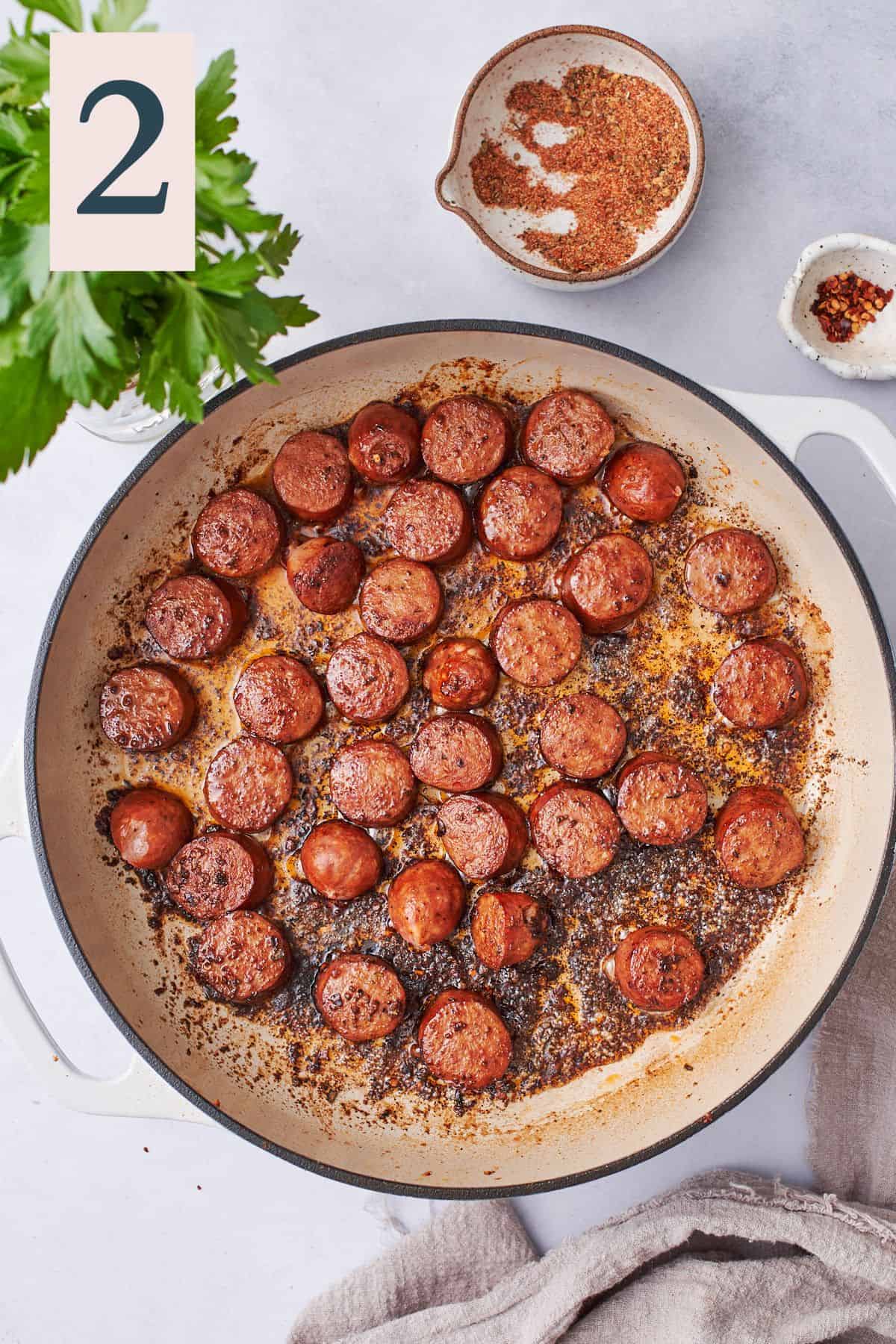 cooked andouille sausage in a cast iron skillet. 