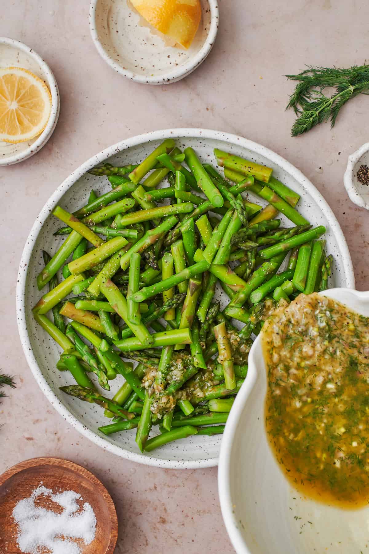 Coating asparagus in dressing mixture.