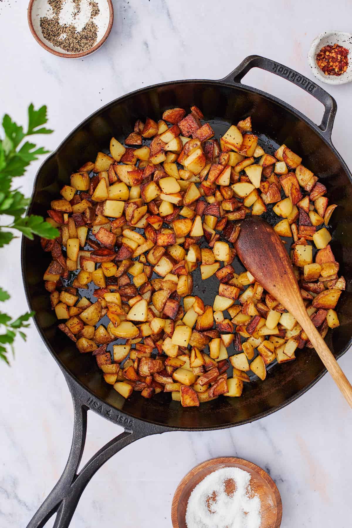 crispy, brown potatoes in a cast iron skillet.