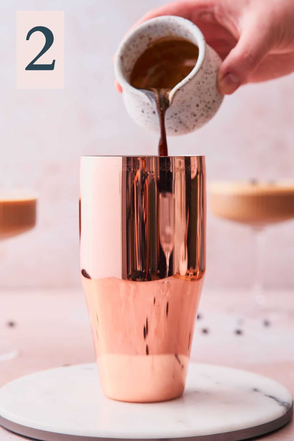 hand pouring espresso into a cocktail shaker. 
