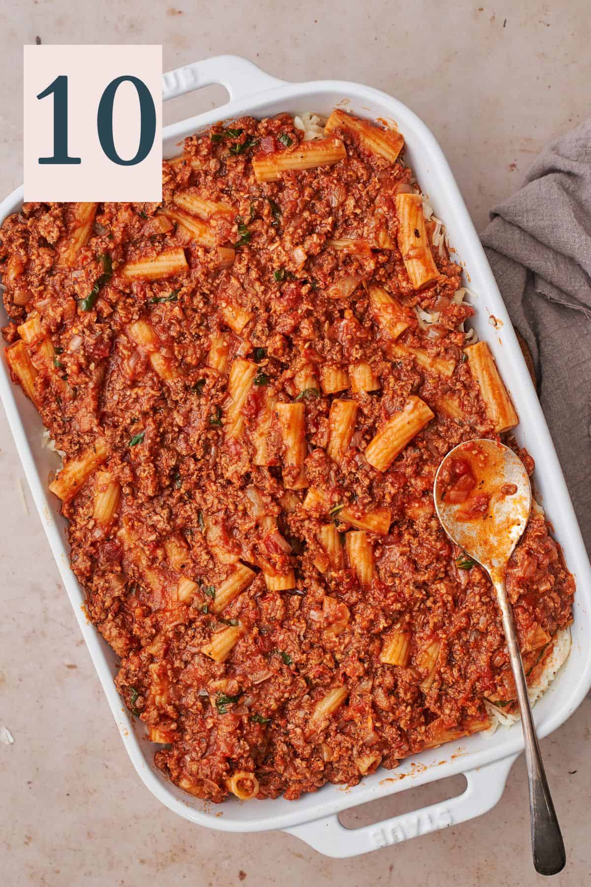 rigatoni with lots of pasta sauce in a rectangular baking dish. 