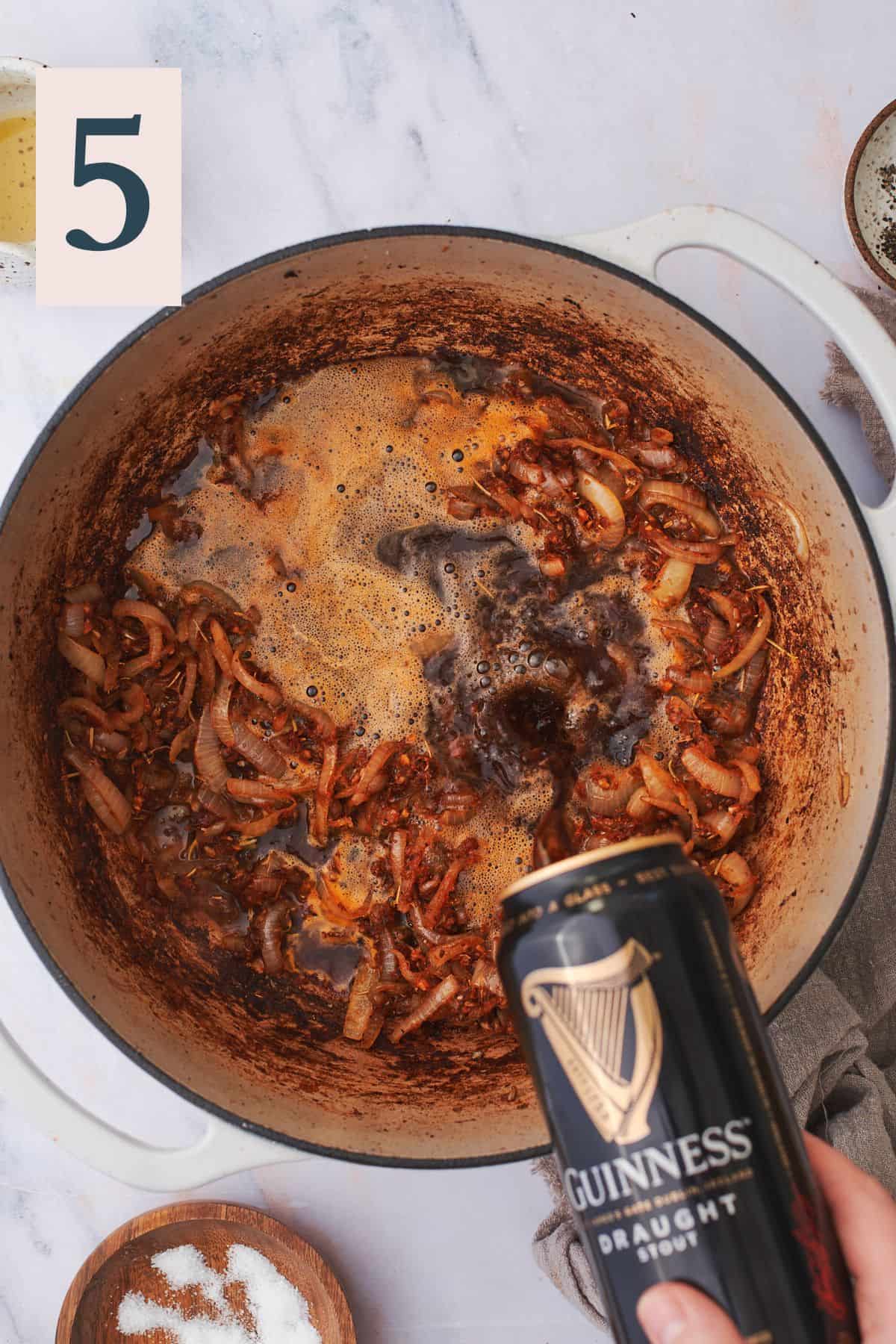 cooked seasonings in a dutch oven, pouring beer into the dutch oven. 