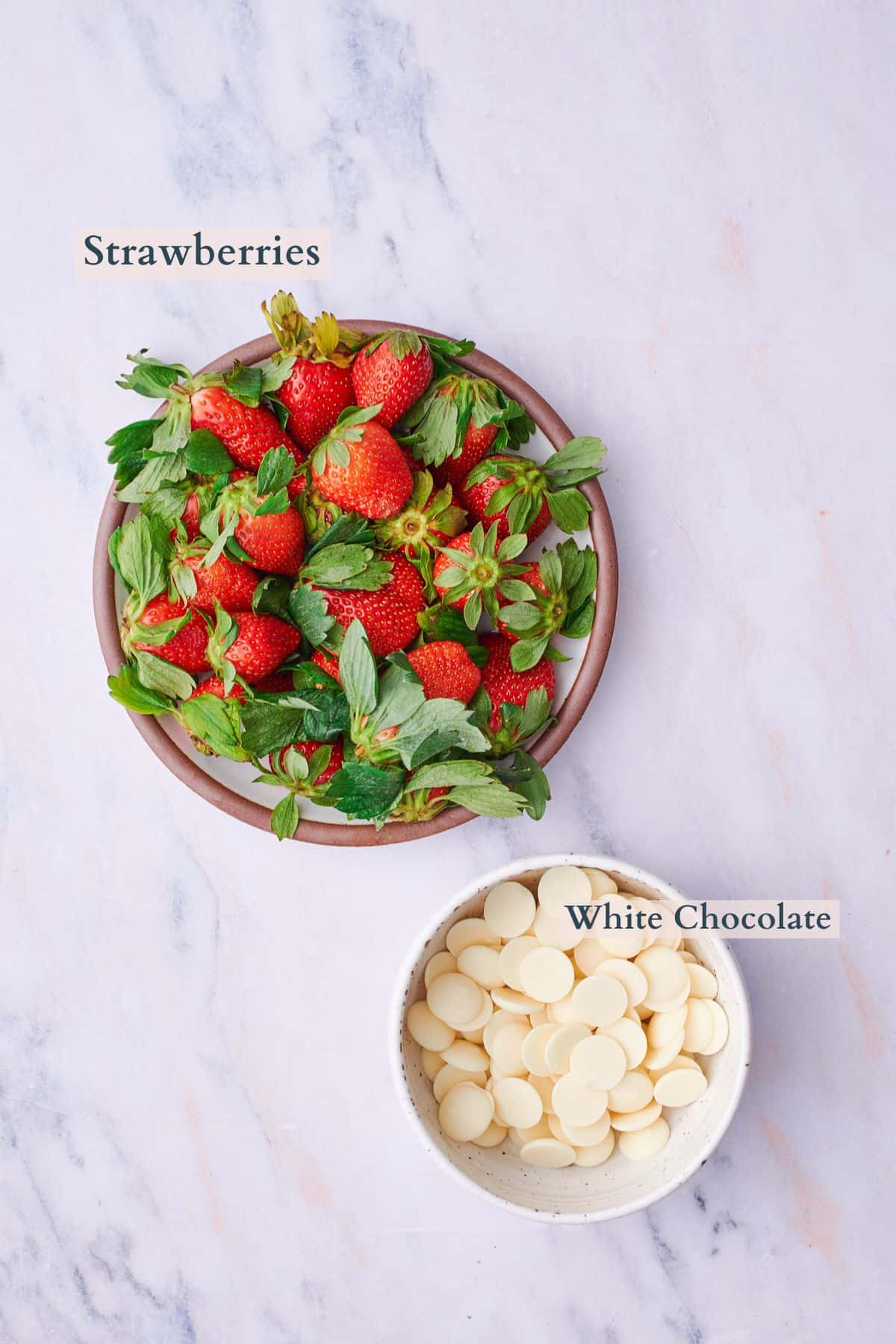 A pile of strawberries and white chocolate wafers.