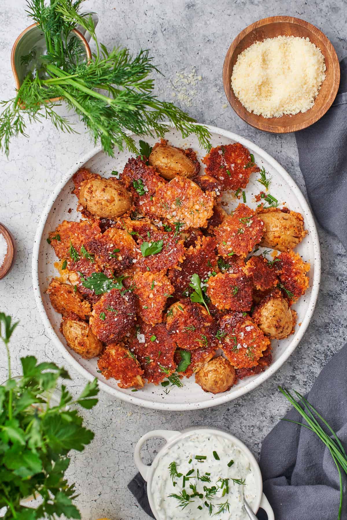 crispy parmesan potatoes with a golden brown parmesan crust and topped with parsley and chives. 