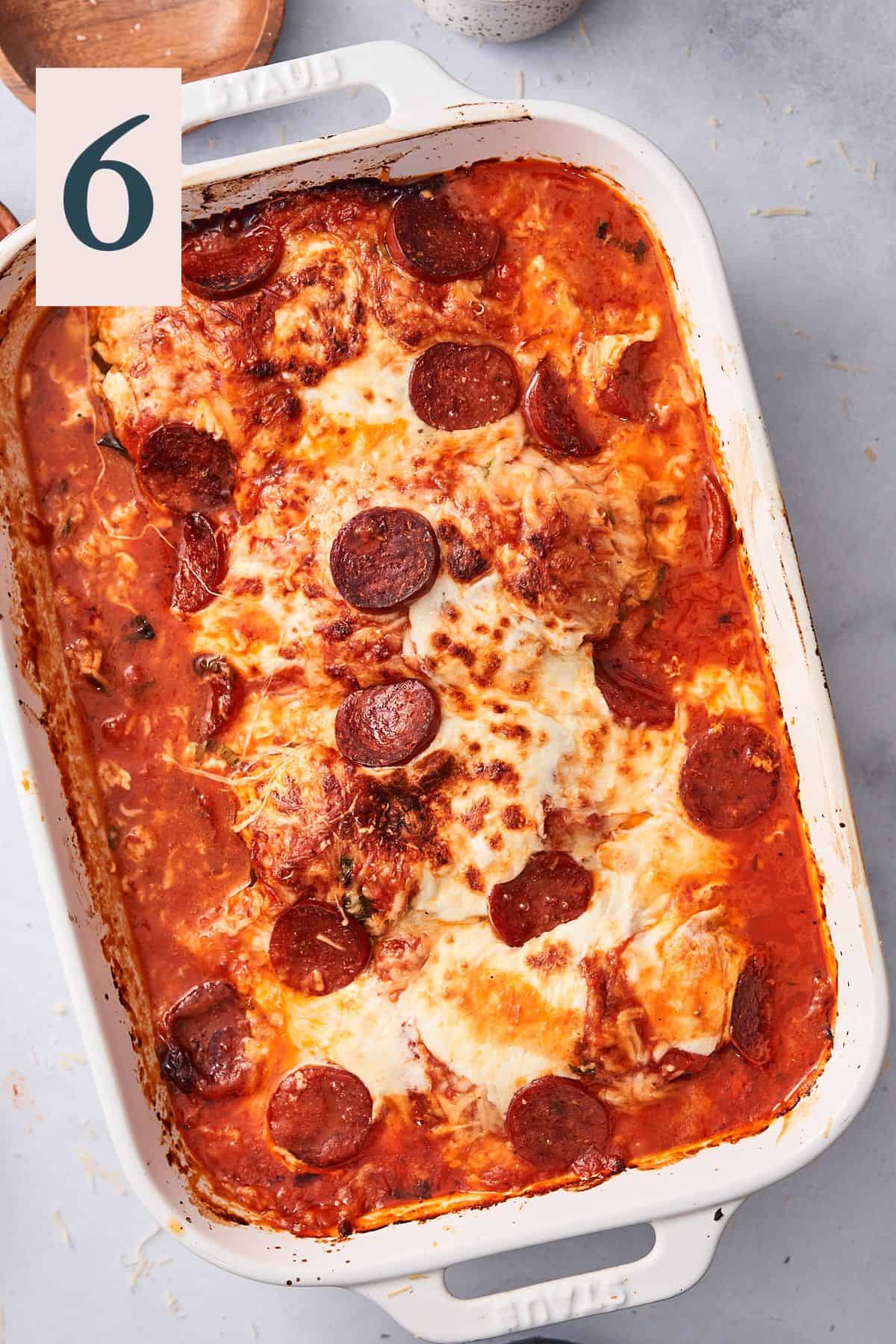 Pizza chicken baked and broiled inside of large casserole dish.