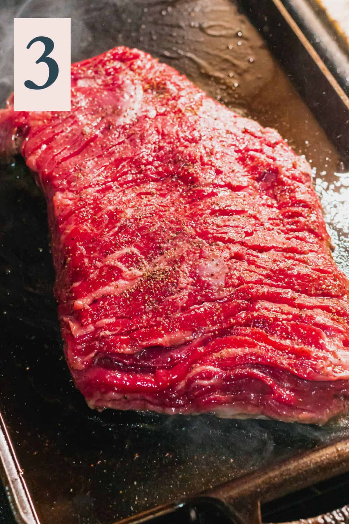 raw bavette steak cooking on a cast iron griddle pan.