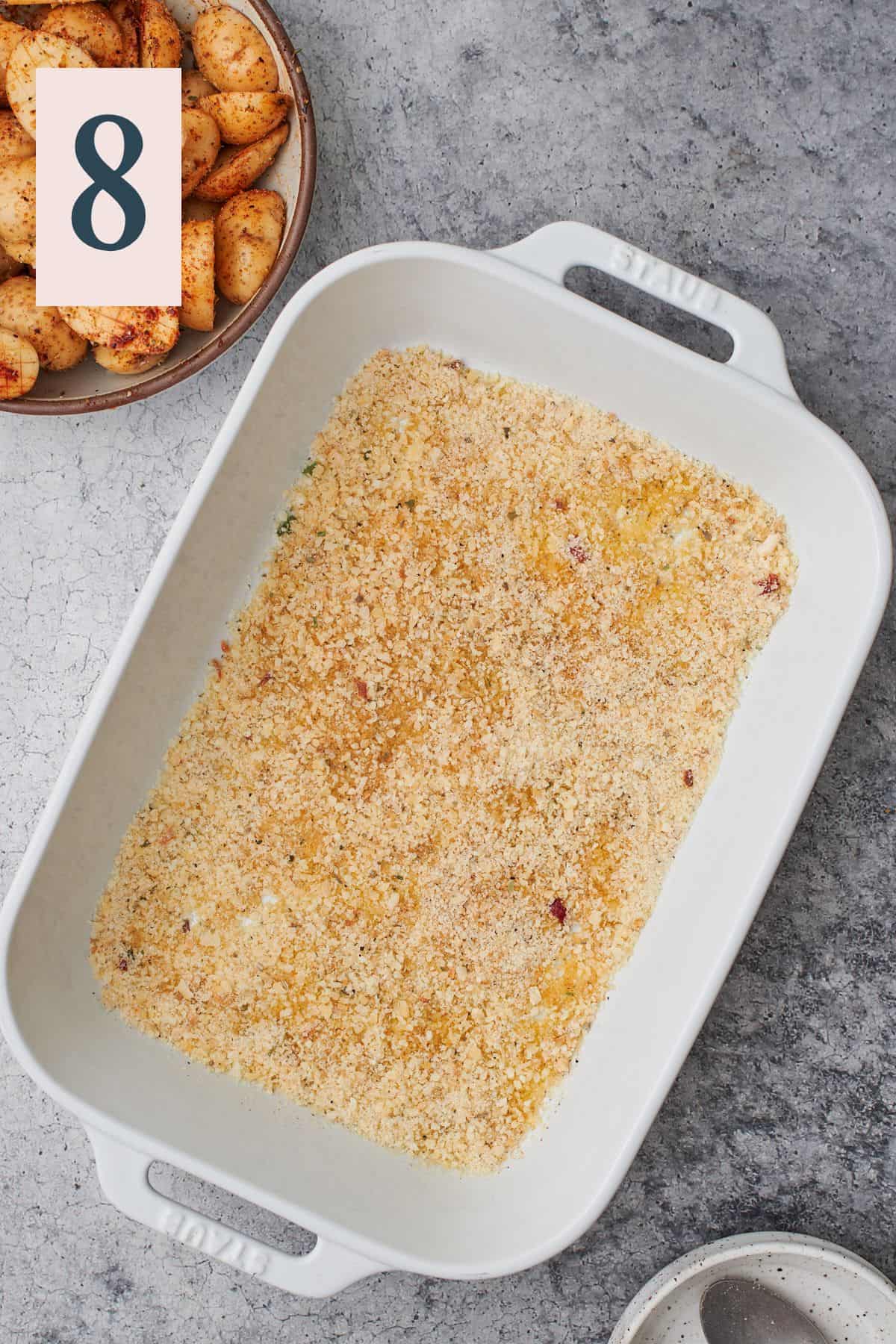 baking dish with a parmesan cheese mixture covering the bottom o the dish. 