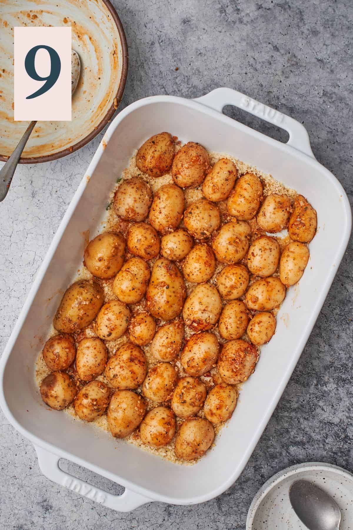 uncooked potatoes on face down on the bottom of a baking dish. 