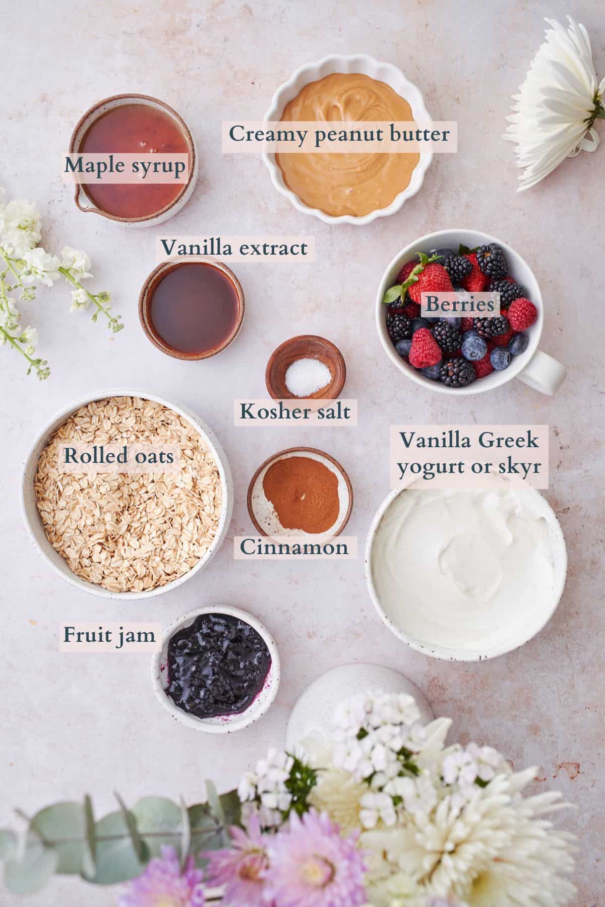 ingredients to make frozen greek yogurt granola bars laid out in small bowls and labeled to denote each ingredient.