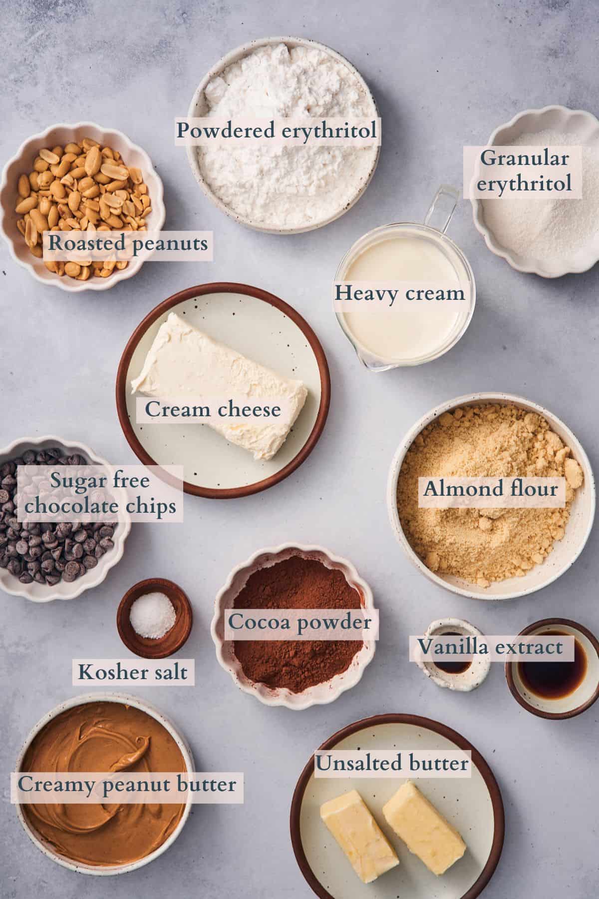 ingredients to make keto peanut butter pie laid out on in small bowls on a table, labeled to denote each ingredient.