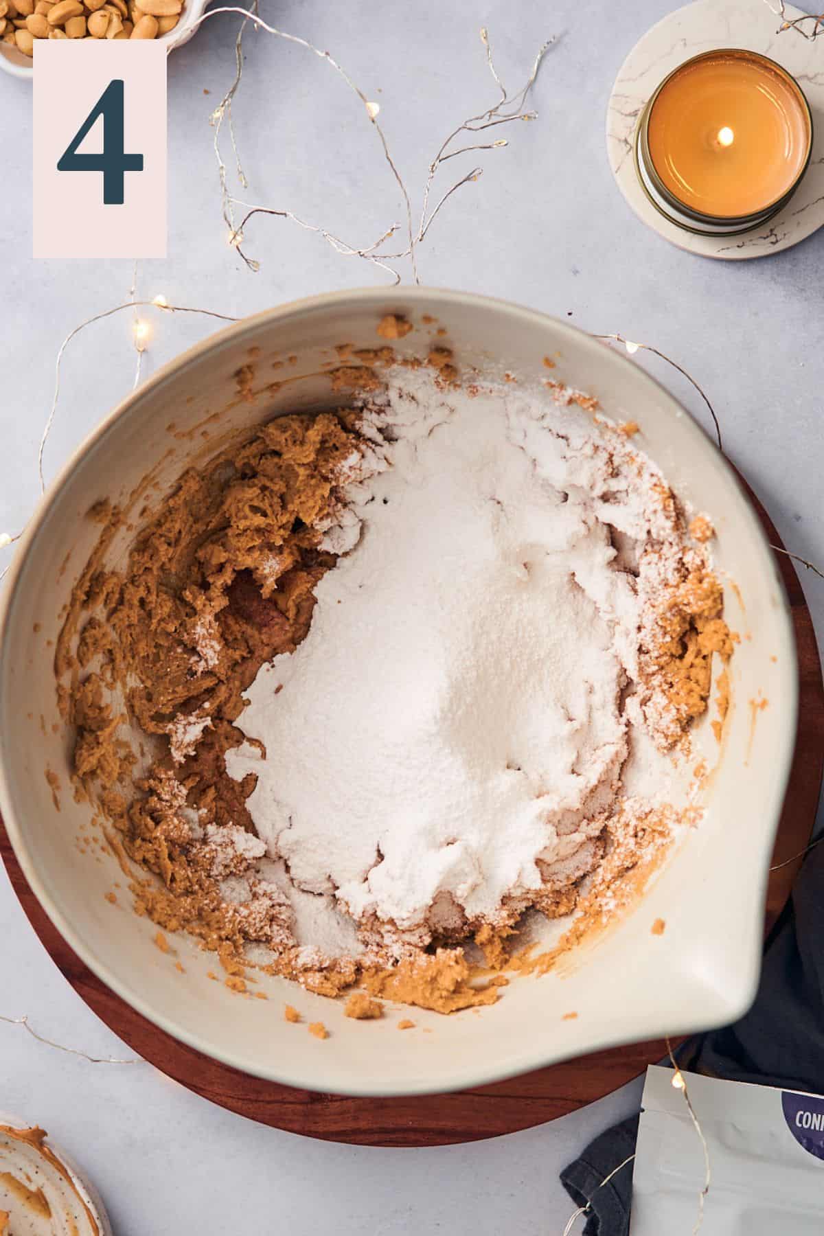 peanut butter filling mixed in a bowl, with confectioners sweetener in a large bowl.