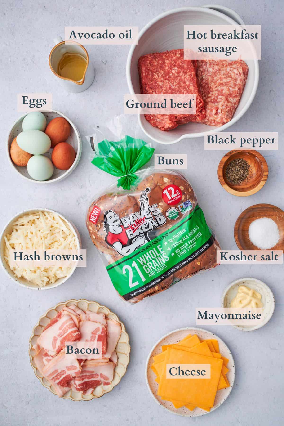 ingredients to make breakfast burgers laid out on a table and labeled to denote each ingredient. 
