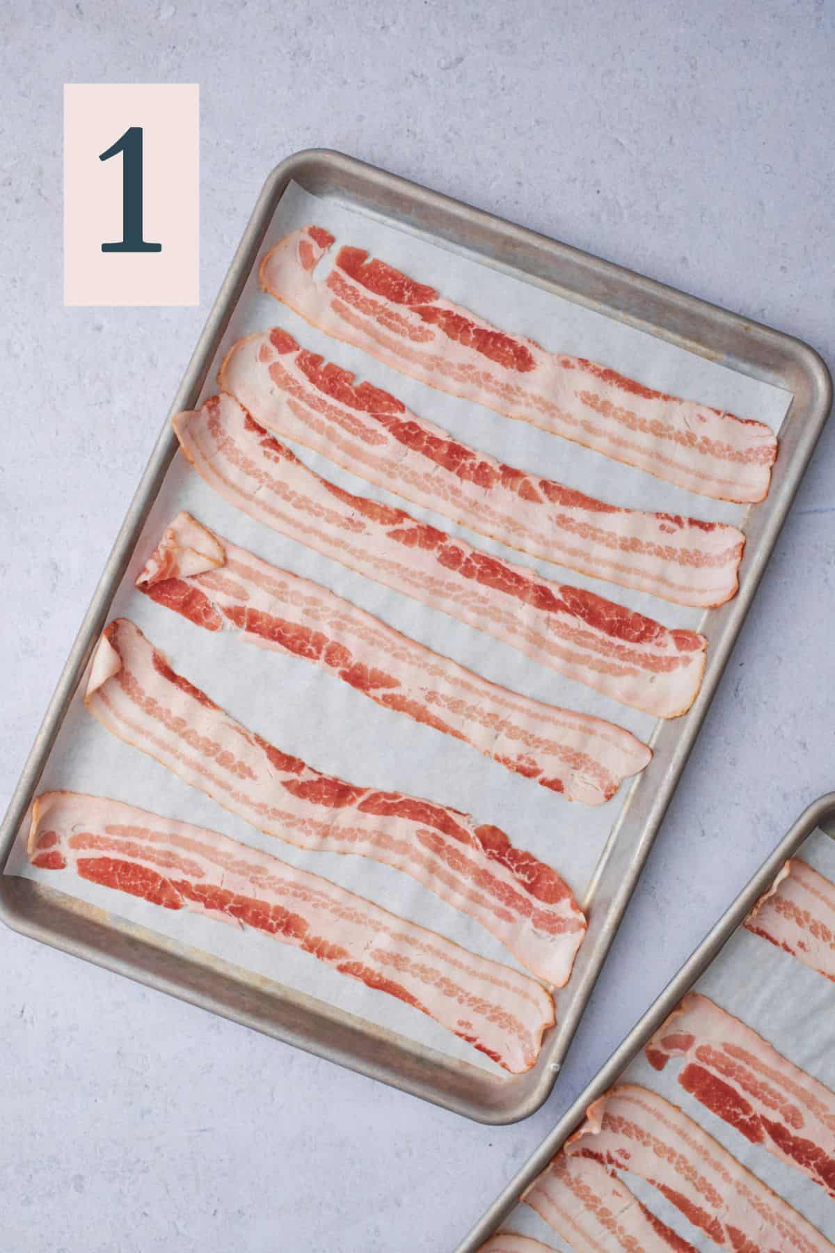 raw bacon on a baking sheet with parchment paper.