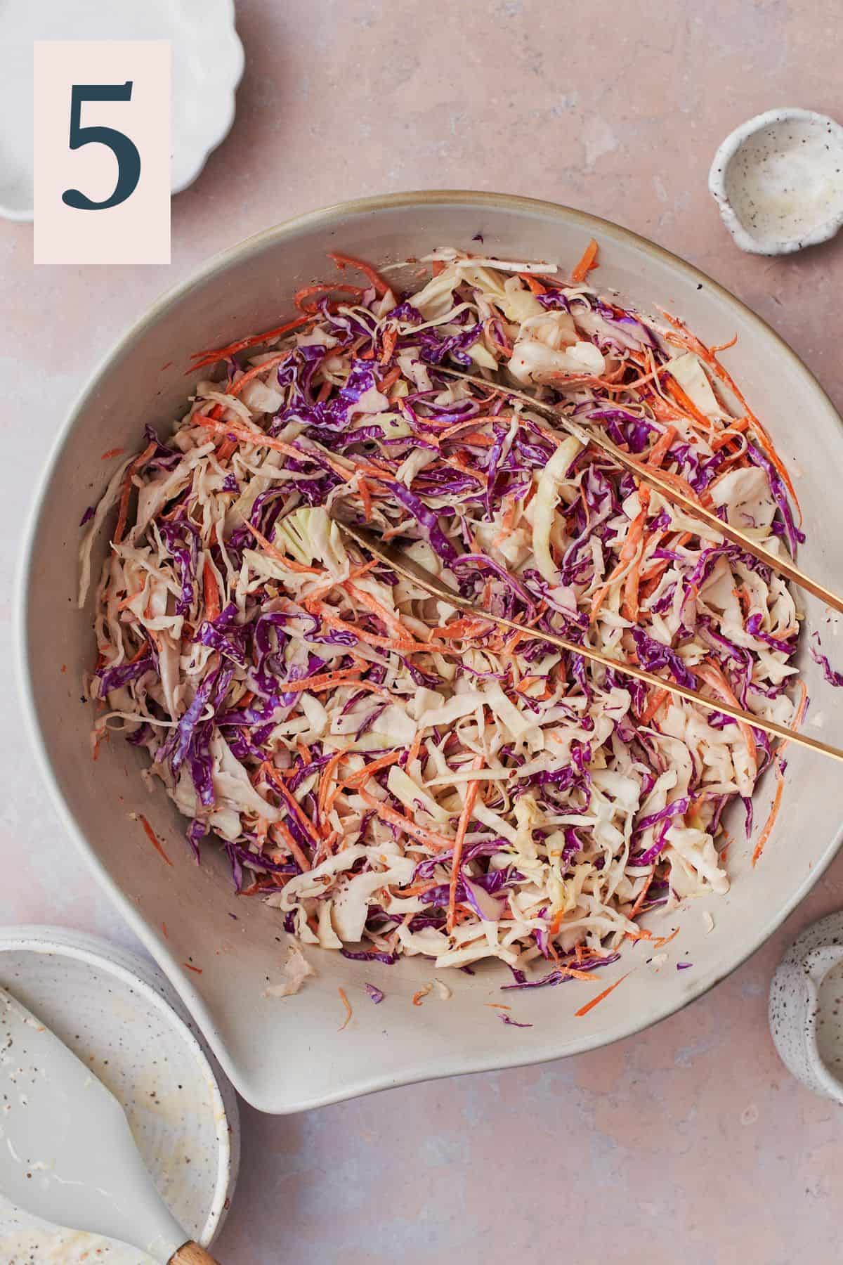 Well mixed keto coleslaw in a large bowl, being ready to serve.