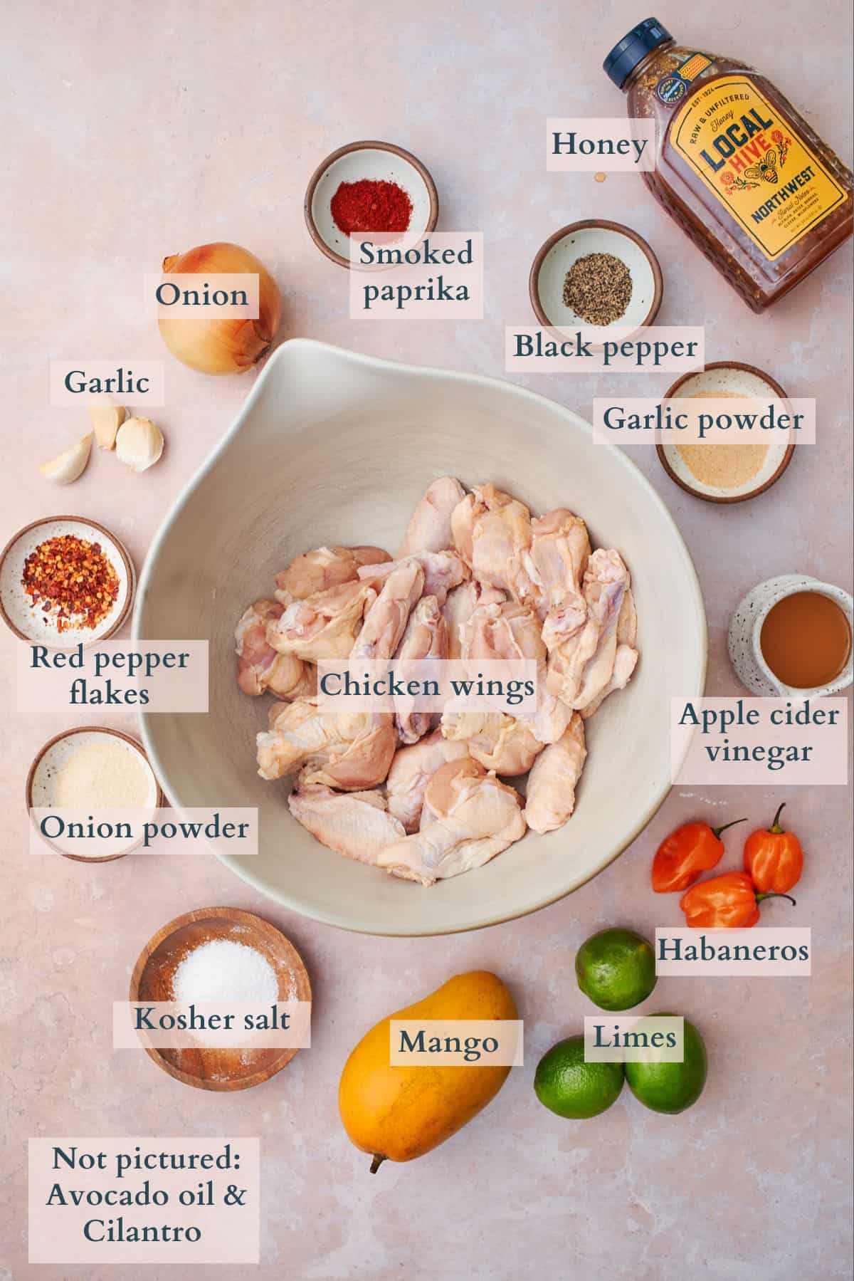 Ingredients to make mango habanero chicken wings labeled to denote each ingredient. 