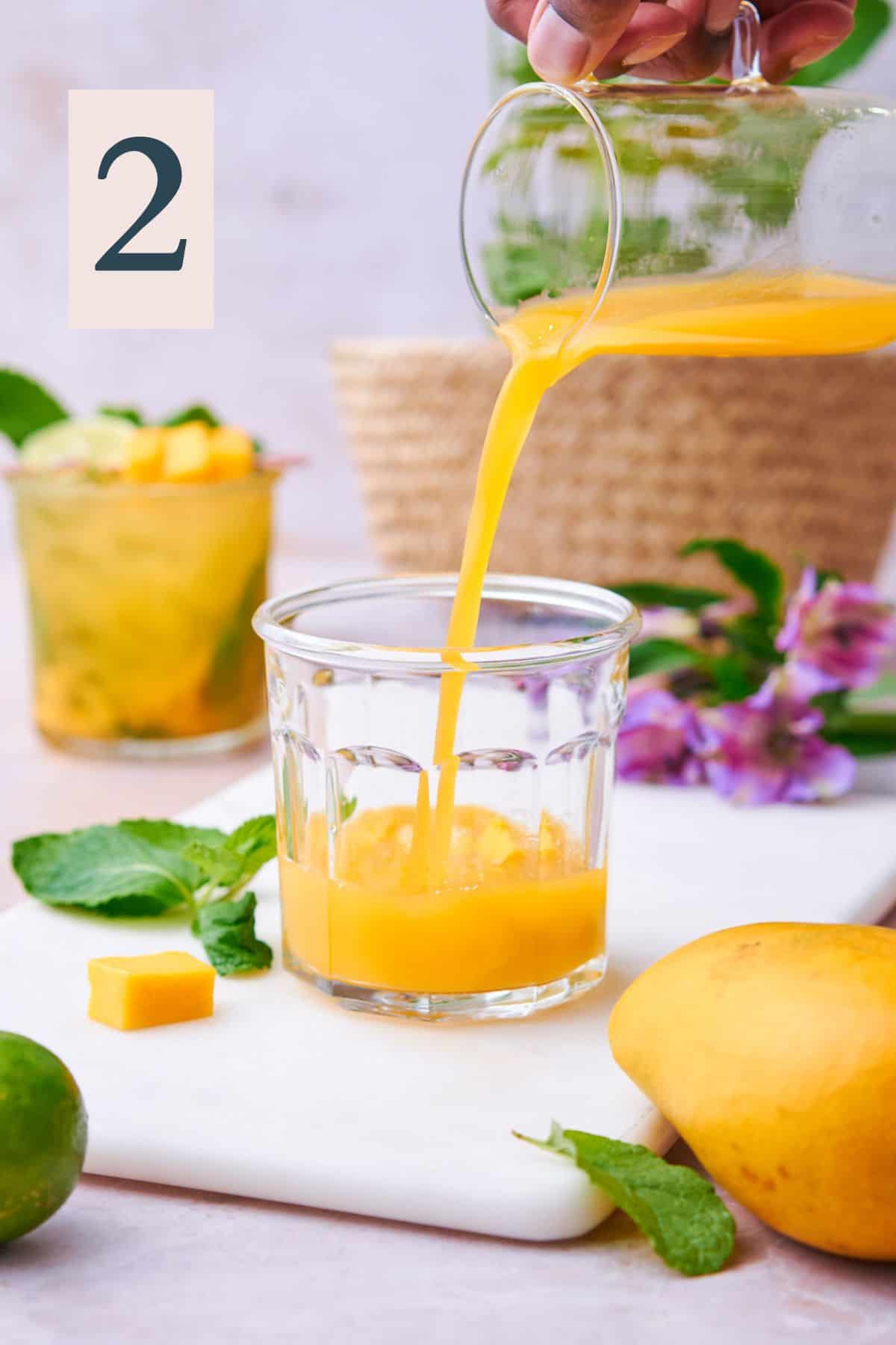Adding mango nectar inside of the short glass.