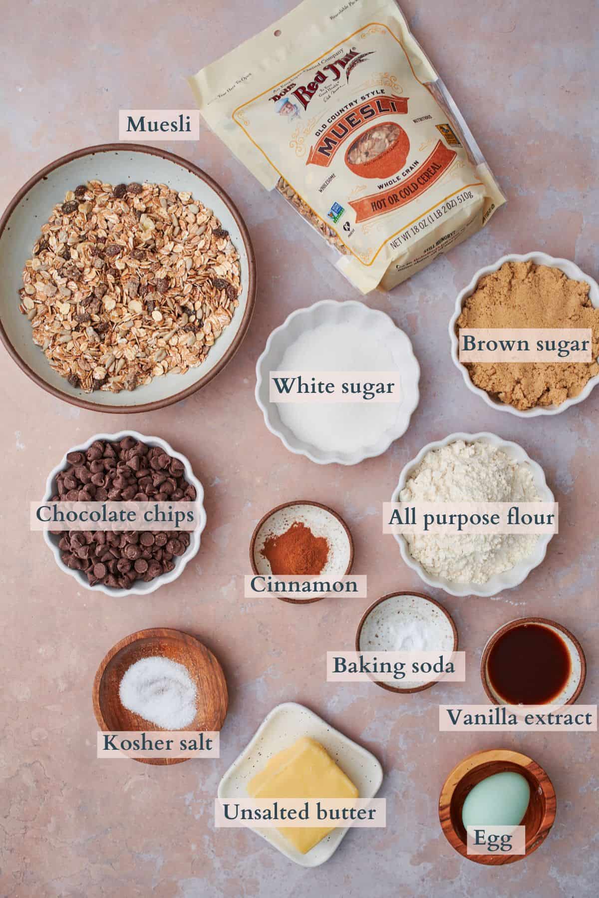 ingredients to make muesli cookies laid out and labeled to denote each ingredient. 