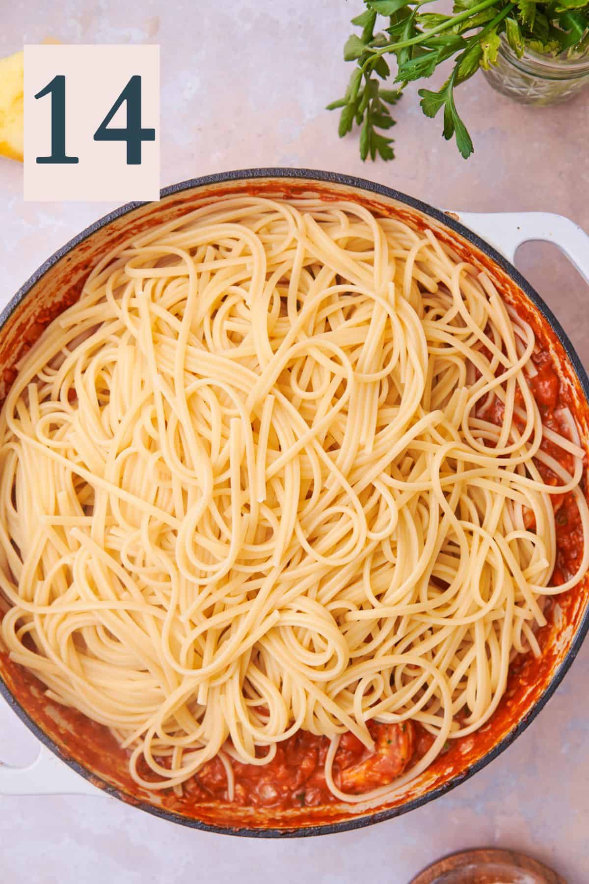cooked linguine in a large skillet with sauce. 