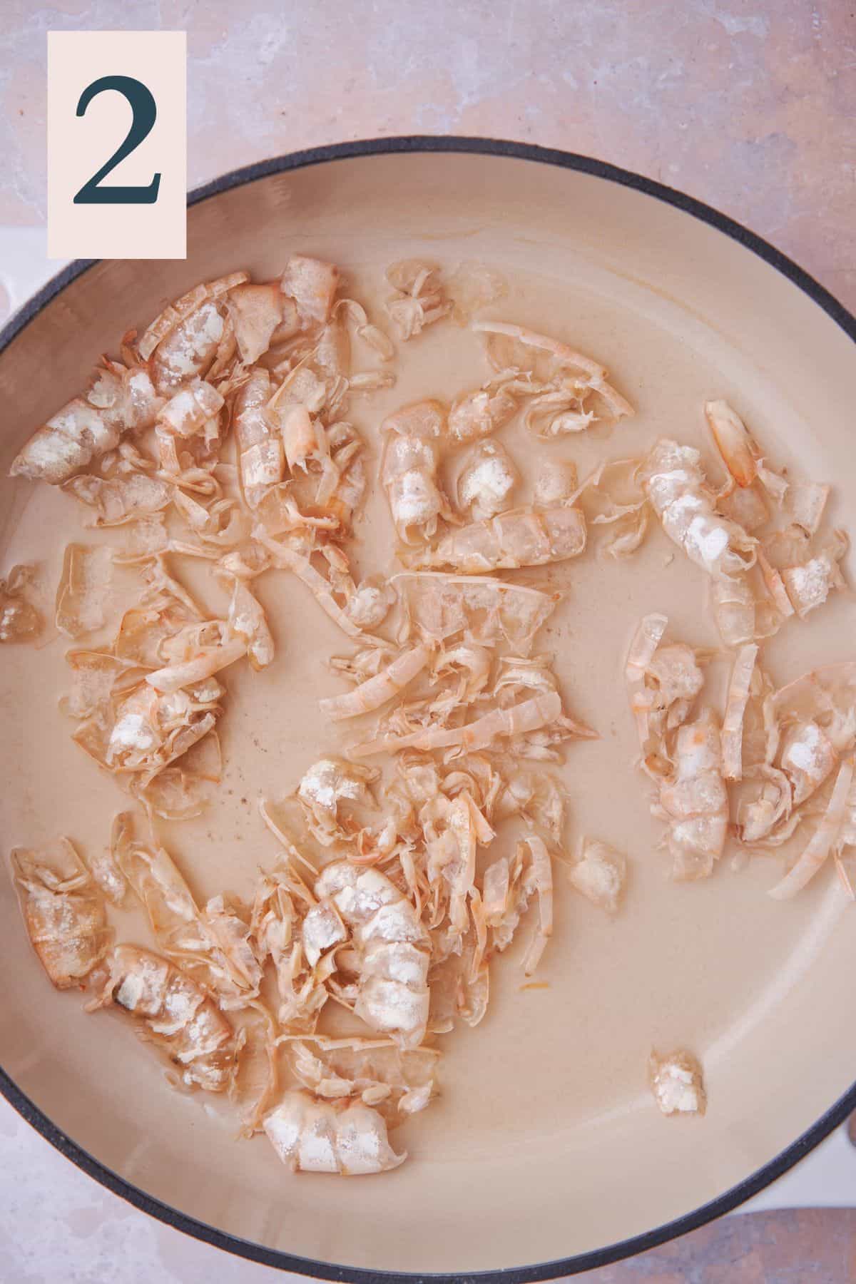 shrimp shells slightly darkened in color with white wine in a large deep skillet. 