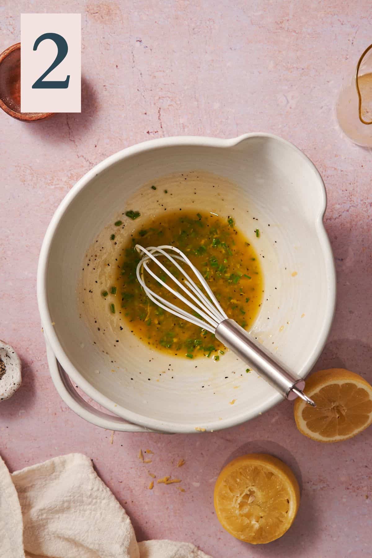 whisked olive oil and chive dressing in a mixing bowl. 