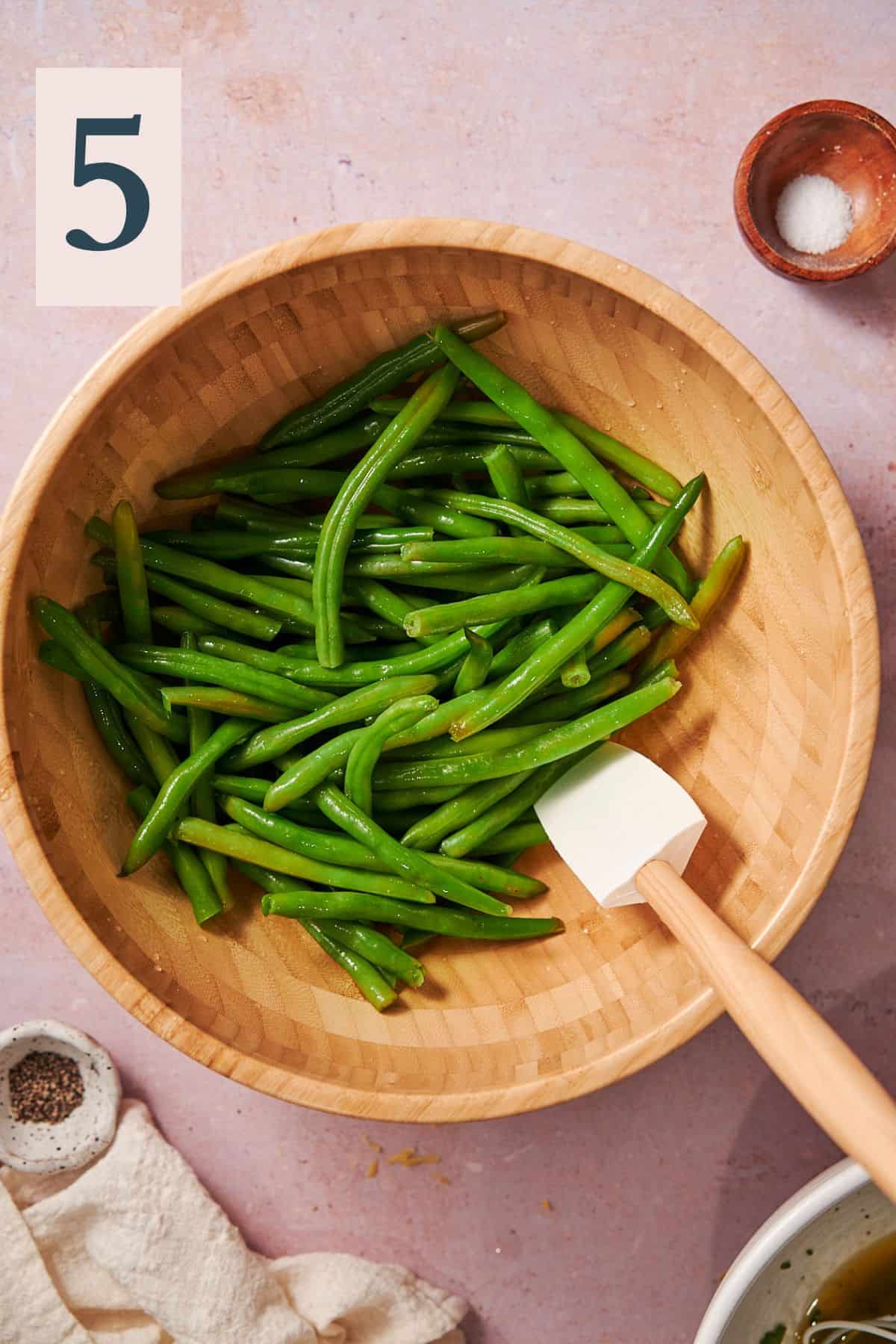 blanched green beans in a large wooden bowl.
