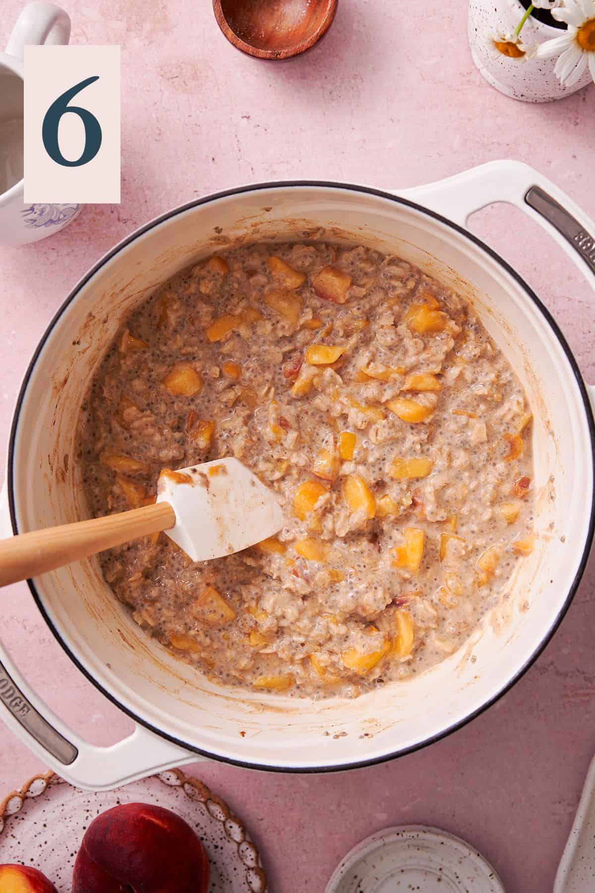 oat mixture with peaches in a dutch oven. 