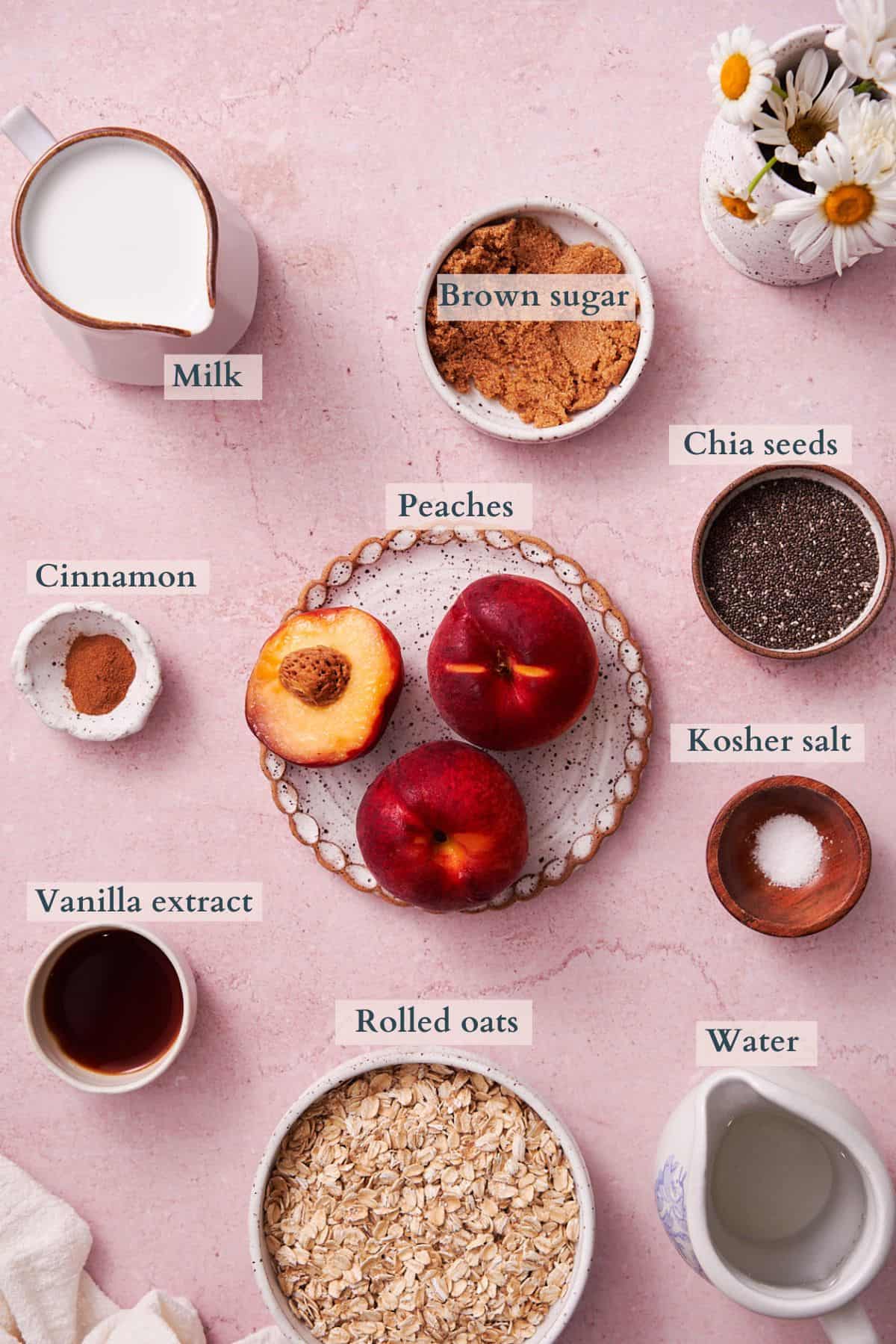 ingredients to make peaches and cream oatmeal laid out in small bowls, labeled to denote each ingredient.