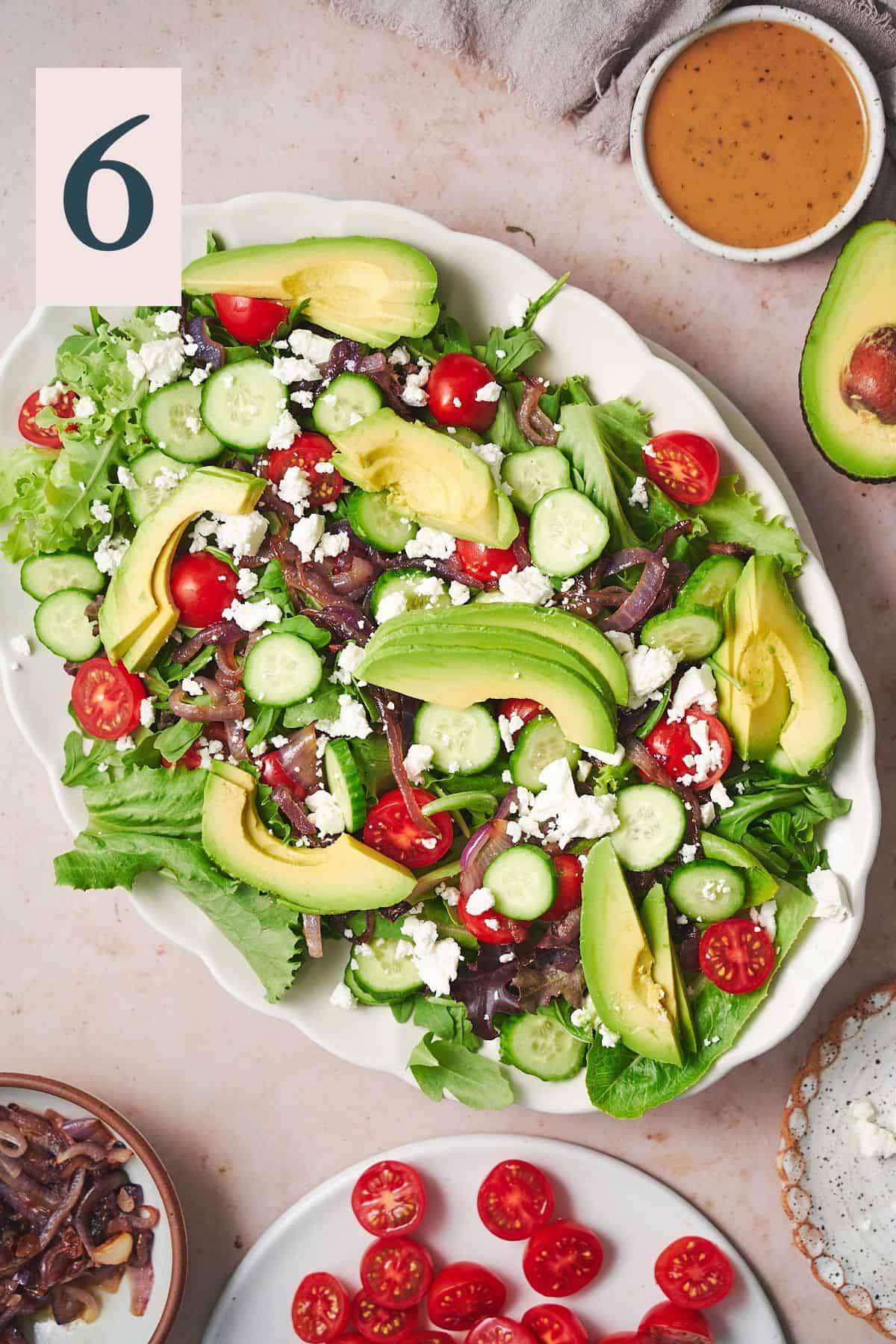 salad with tomatoes, feta, grilled onions, cucumbers, and avocado. 