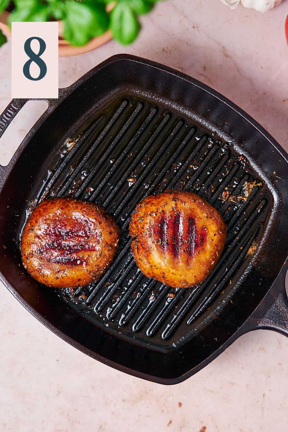 Portobello caps on a cast iron grill pan. 