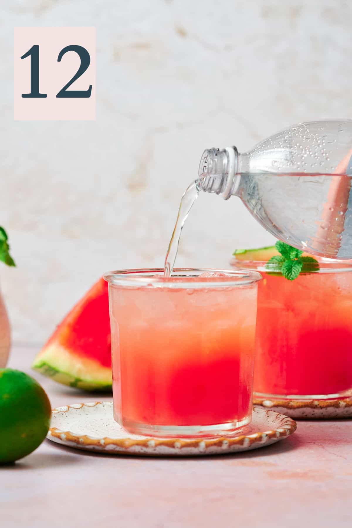watermelon cocktail being topped off with club soda. 