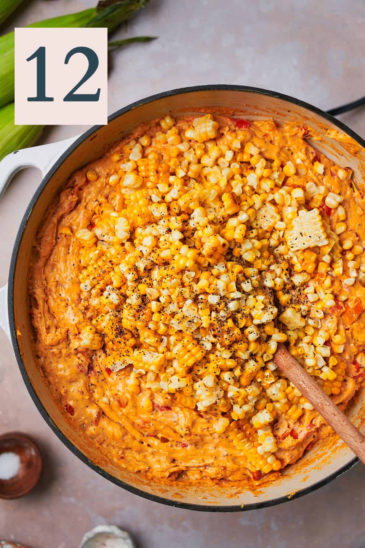 grilled corn added to a cheesy dip mixture in a skillet. 
