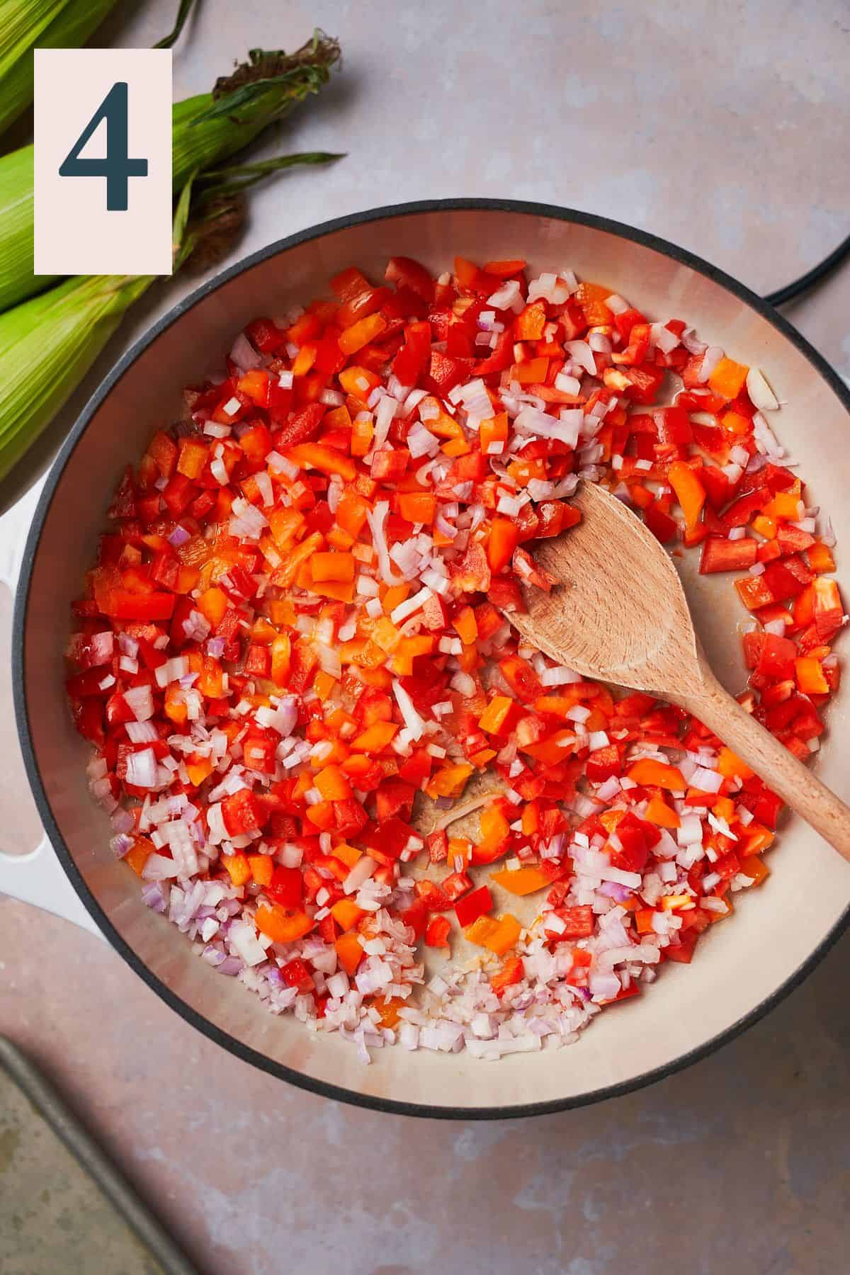 Shallots and bell peppers in a skillet.