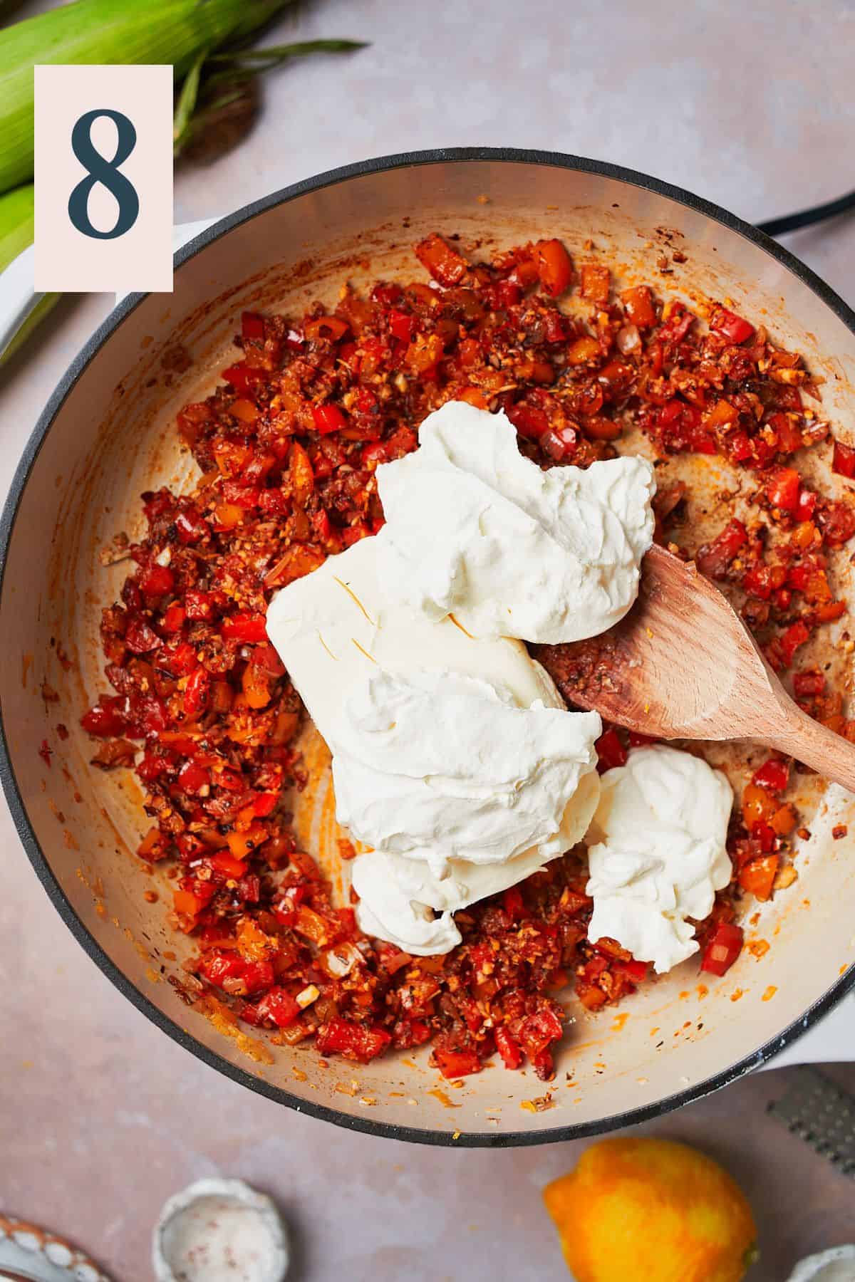 sour cream and cream cheese in a skillet with cooked peppers. 