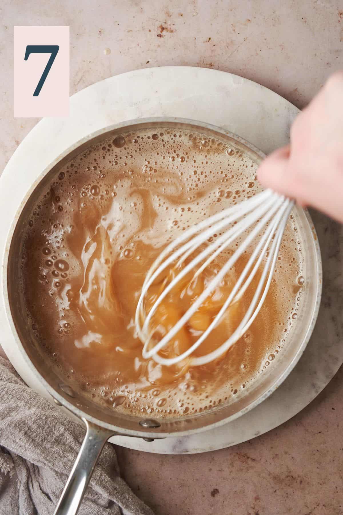 caramel mixture coming together in a saucepan by whisking fast with a silicone whisk. 