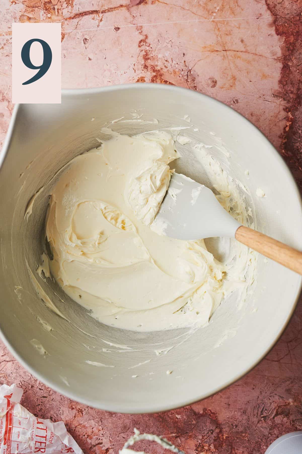 softened butter that is pale and fluffy in a large mixing bowl.