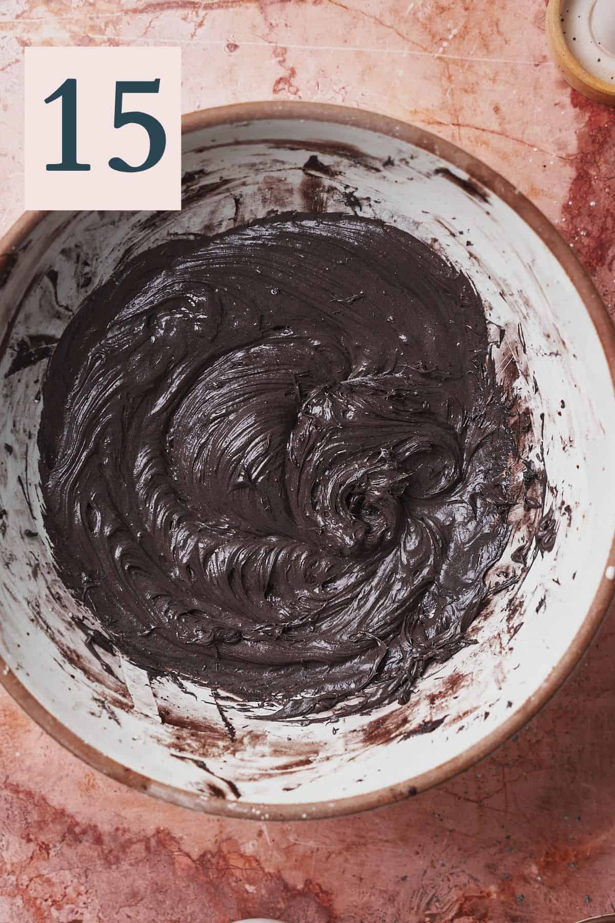 dark black cocoa powder frosting in a large bowl. 